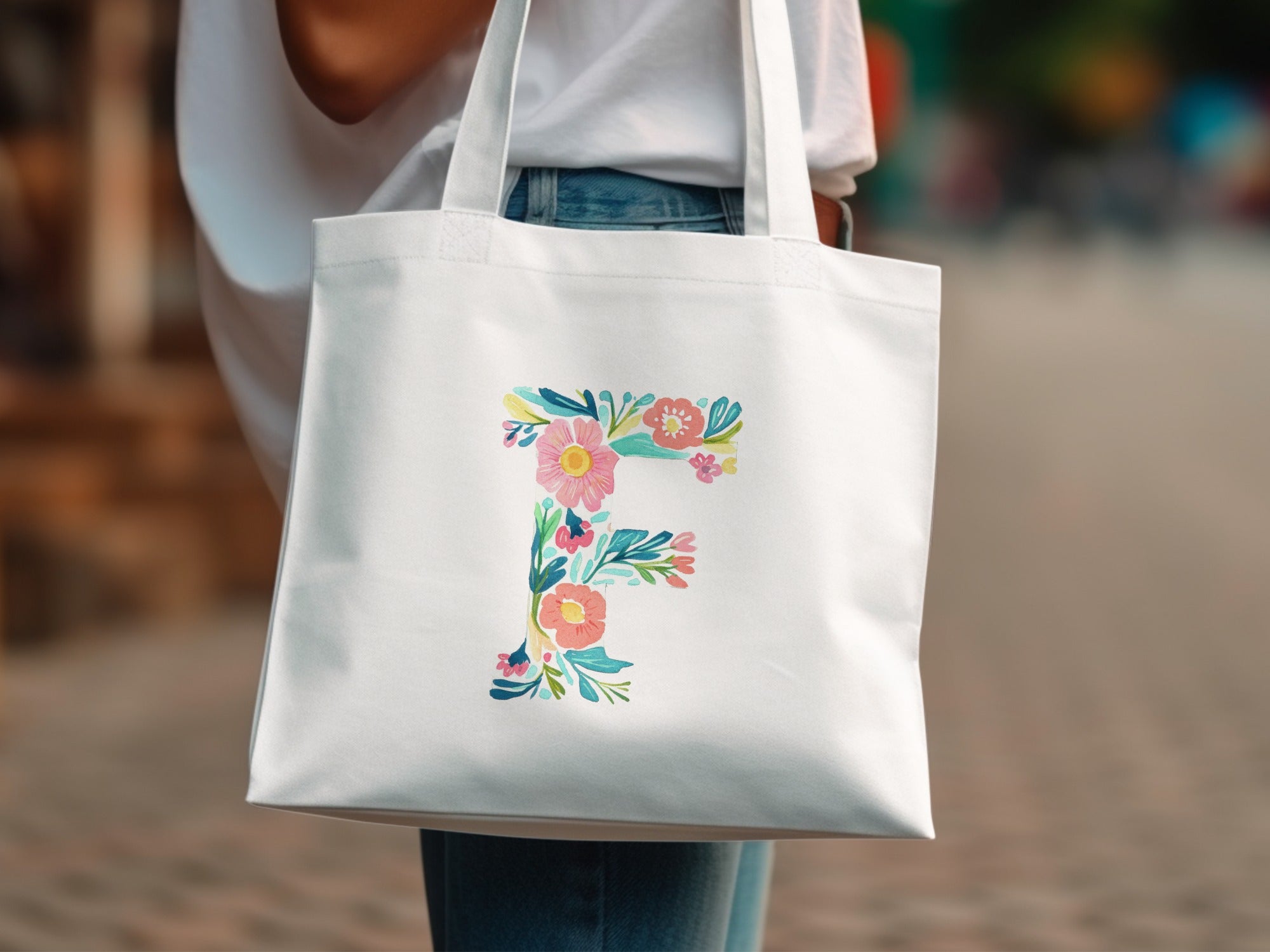 White tote bag with a floral letter F design.