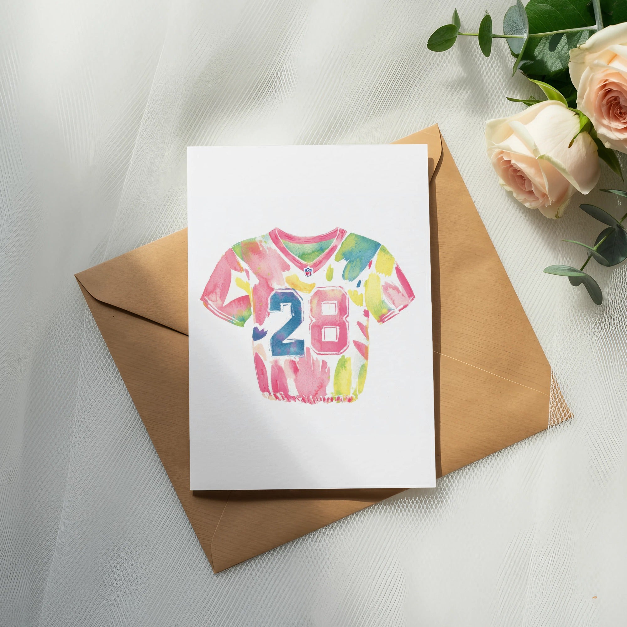 Watercolor football jersey with number 28 on card over envelope.