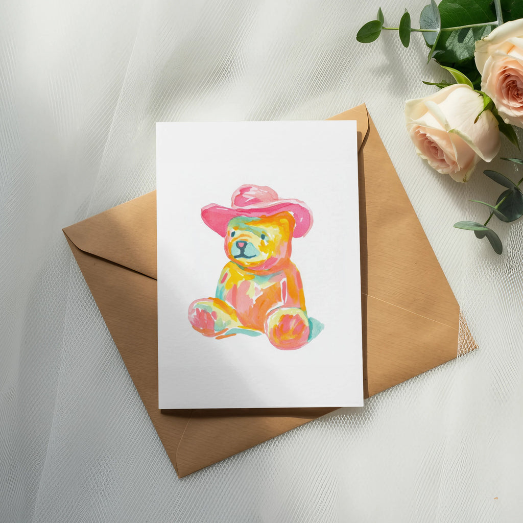 Watercolor teddy bear wearing a pink cowboy hat on a card.