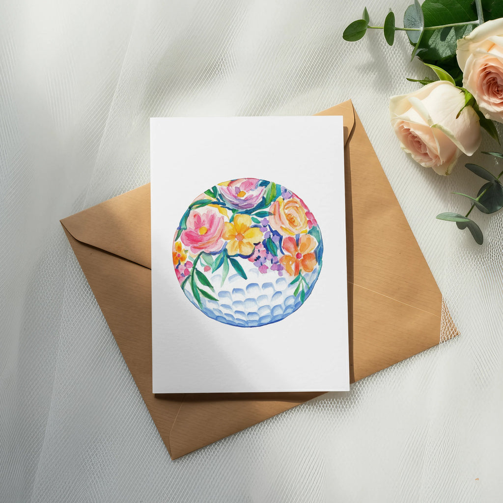 Card with watercolor floral golf ball design on brown envelope.
