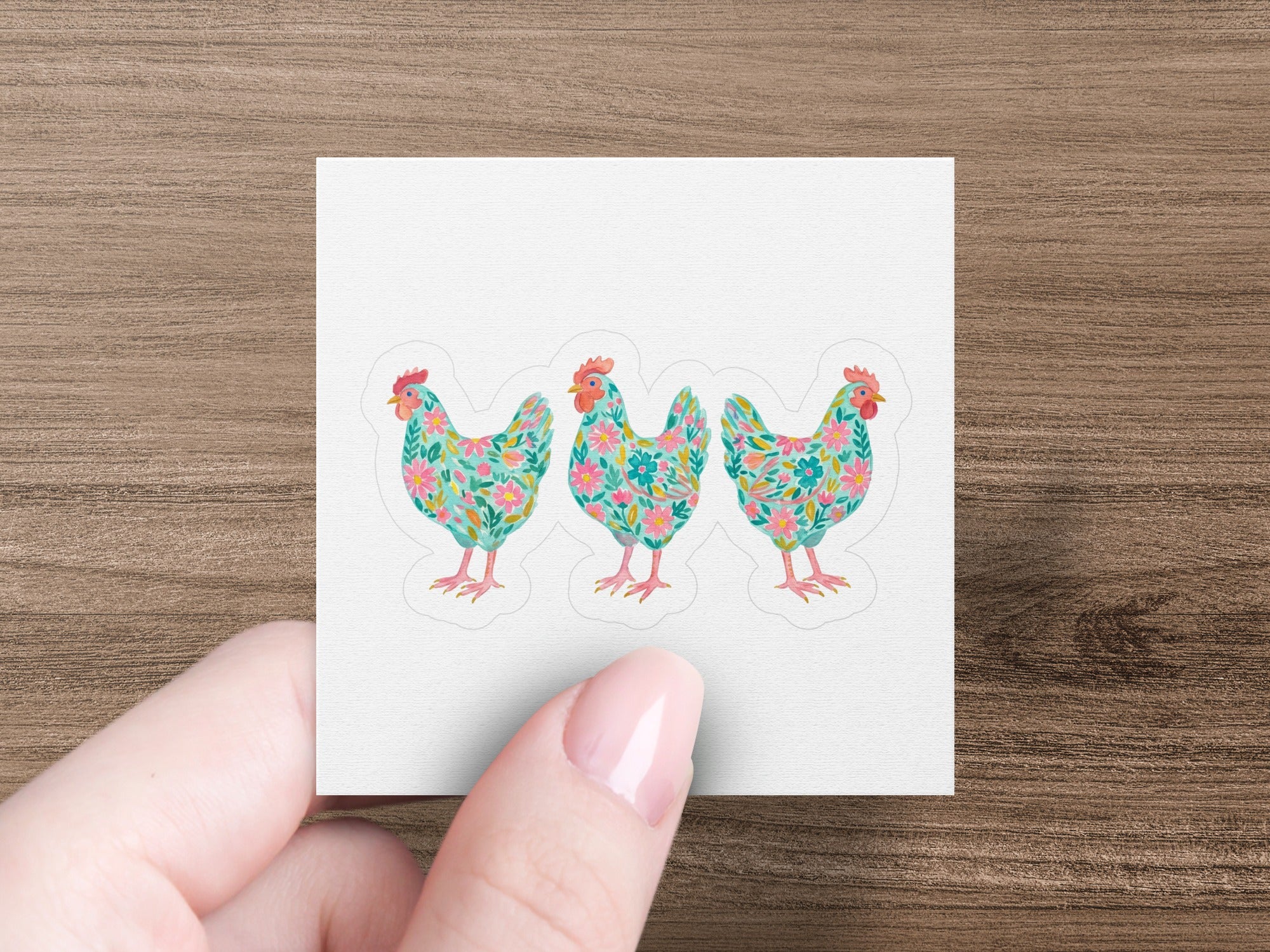 Three floral patterned chickens on a white square sticker.