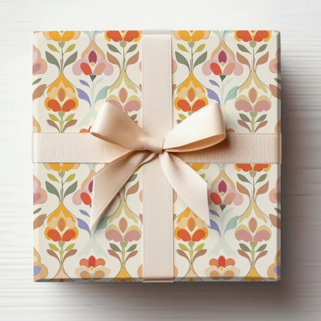 Gift-wrapped box with a beige ribbon and a floral pattern.