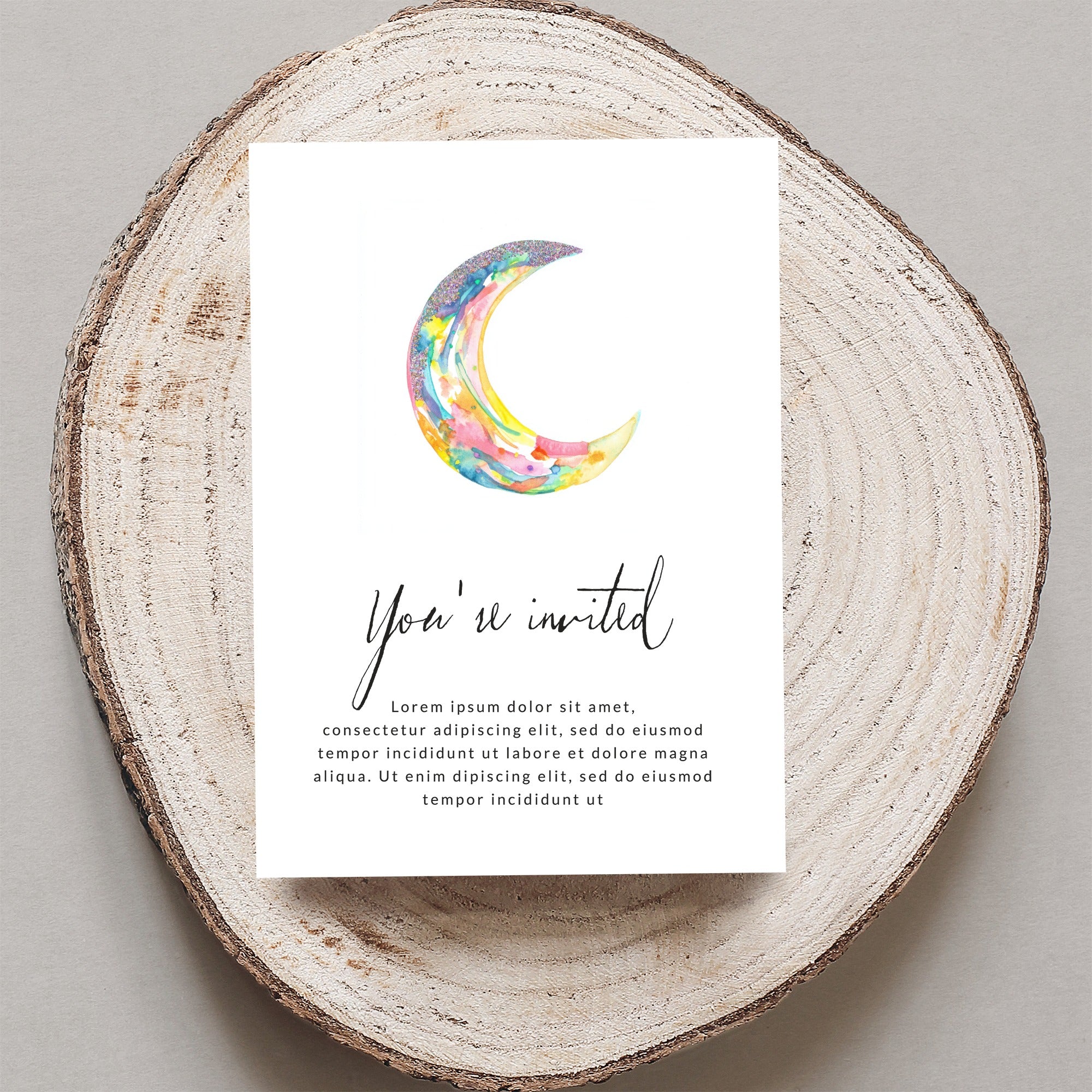 Watercolor crescent moon and "You're invited" text on card.