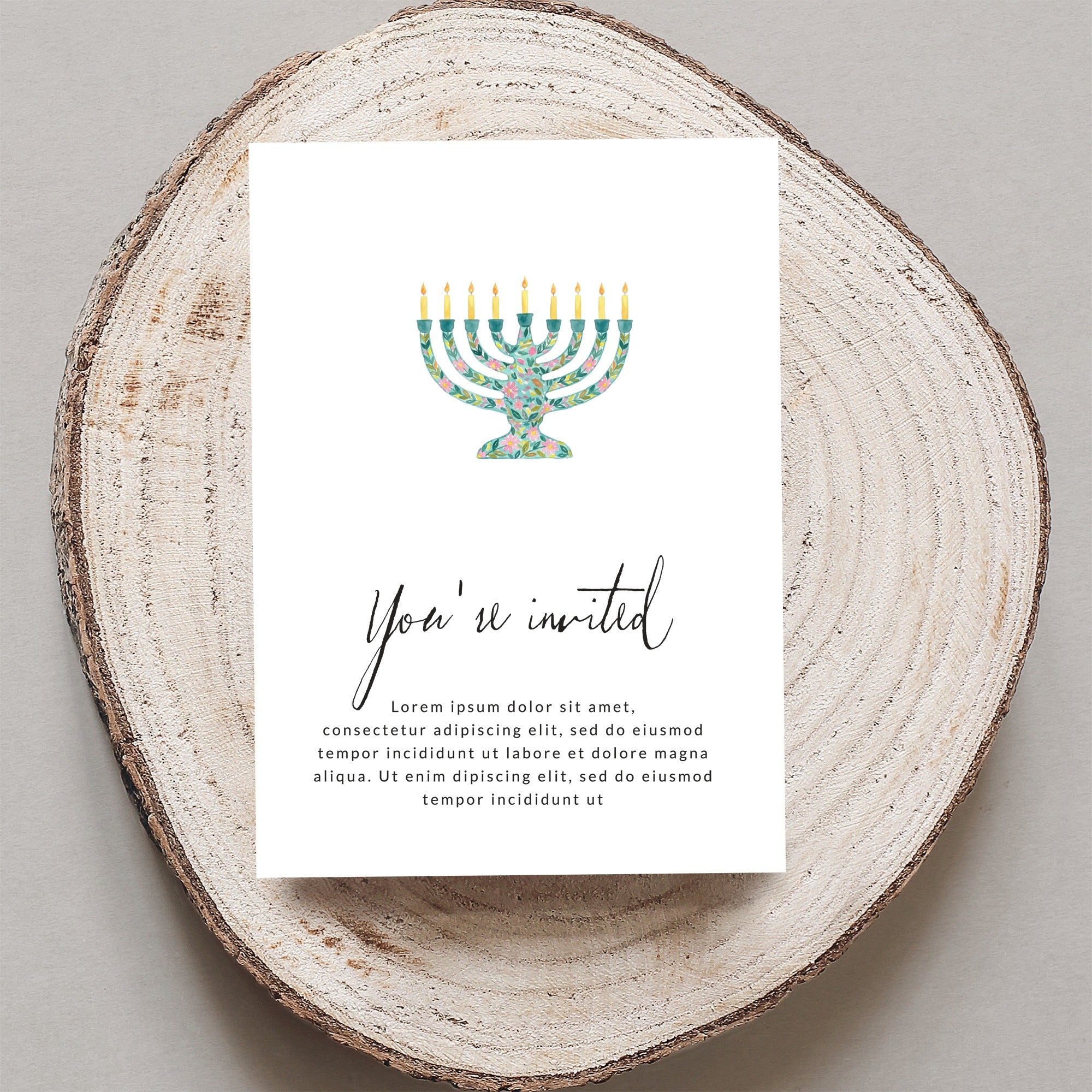 Invitation with floral menorah and "You're invited" text.