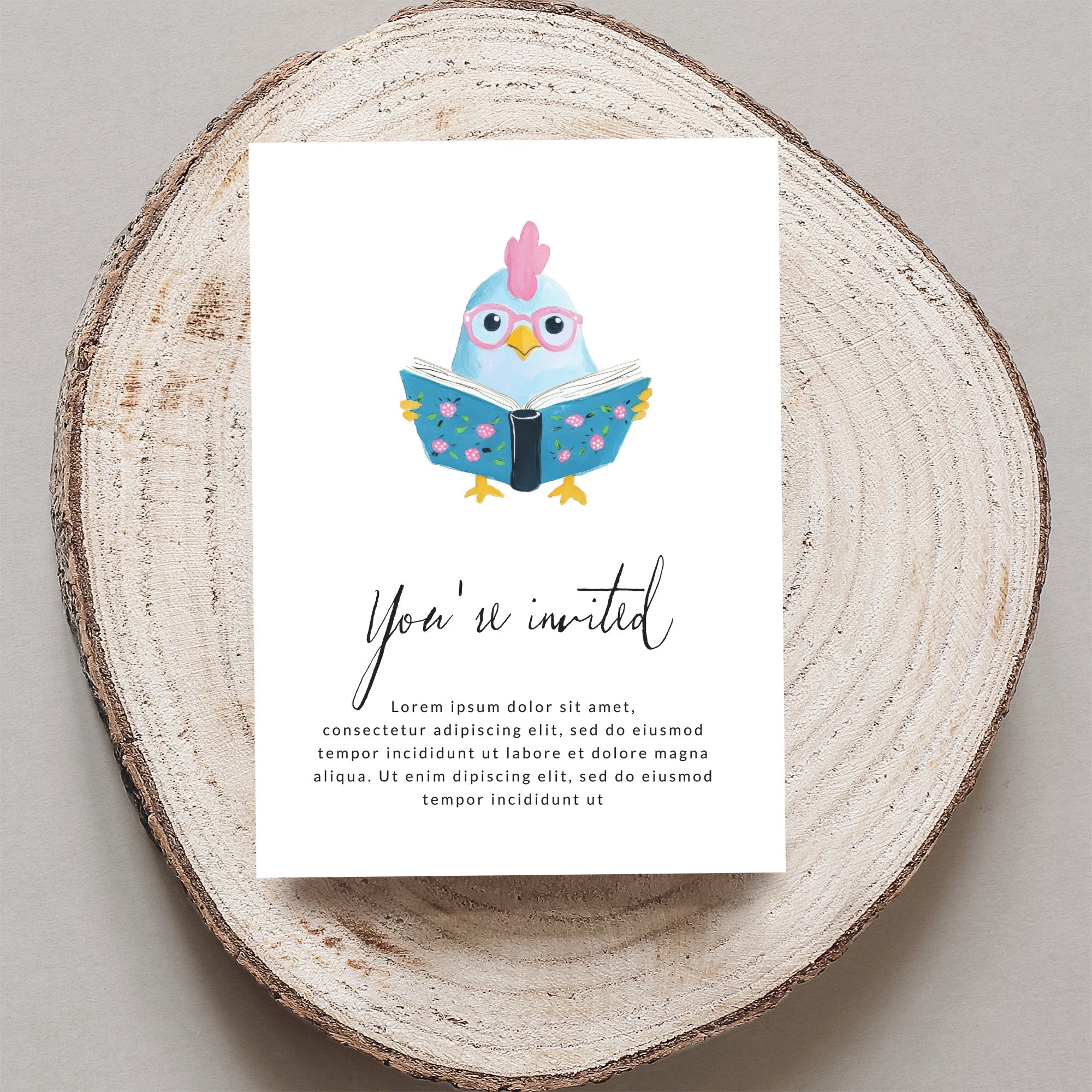 Cute chicken wearing glasses reads a book on a card that says "You're invited."