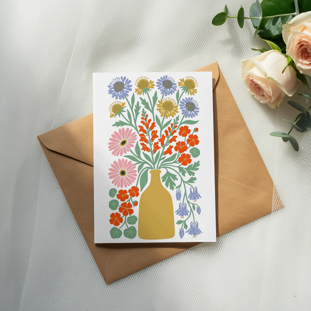 Card with colorful floral illustration in a yellow vase on a brown envelope.
