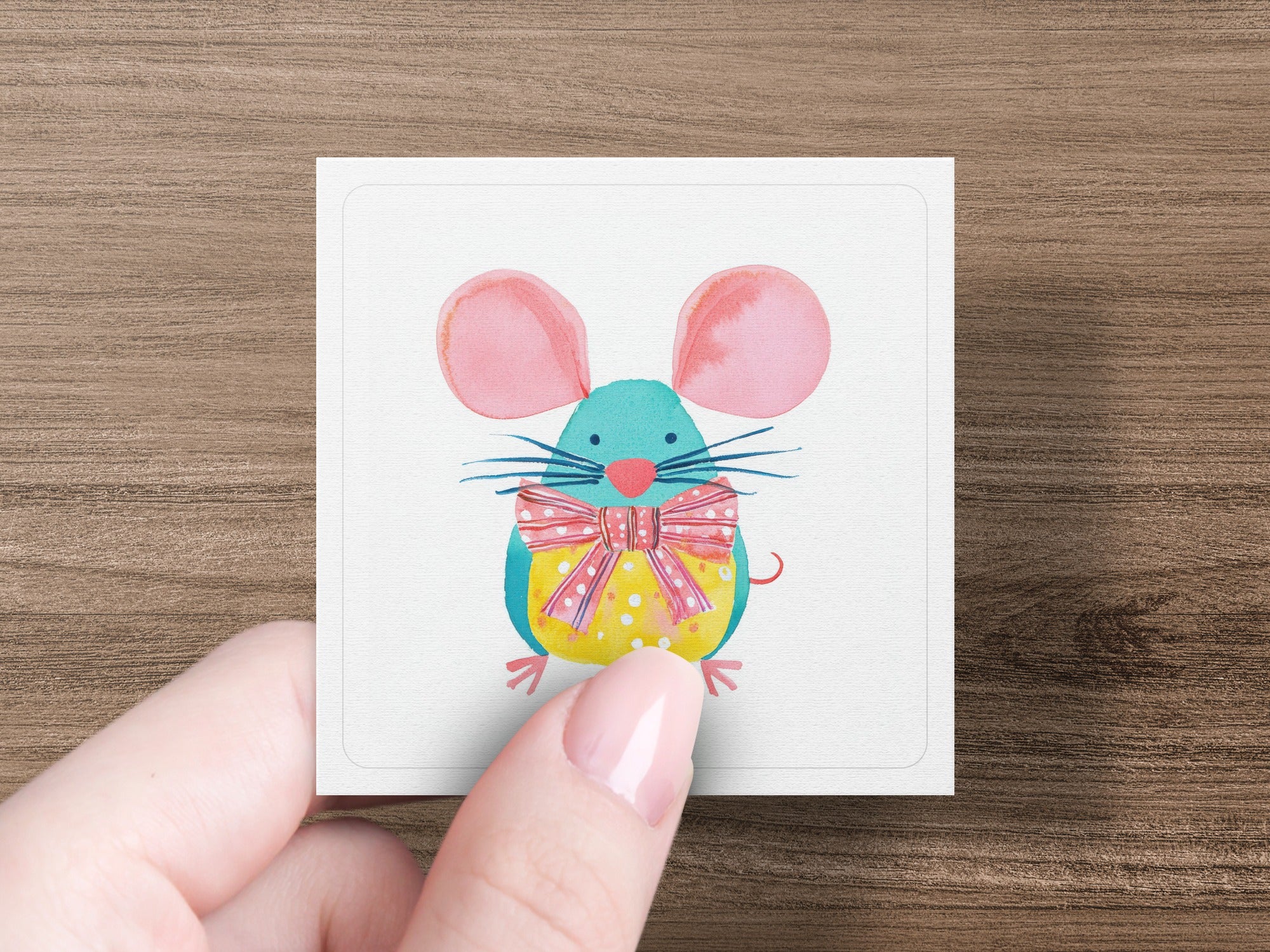 Cartoon mouse with pink ears and polka dot body wearing a yellow bow tie.