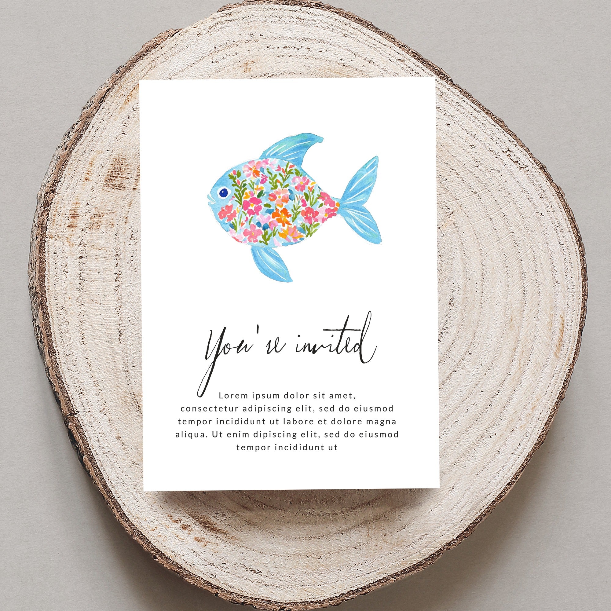 Watercolor invitation with floral fish and placeholder text.