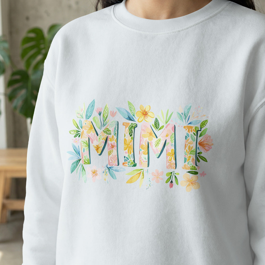 White sweatshirt with "MIMI" in floral lettering.