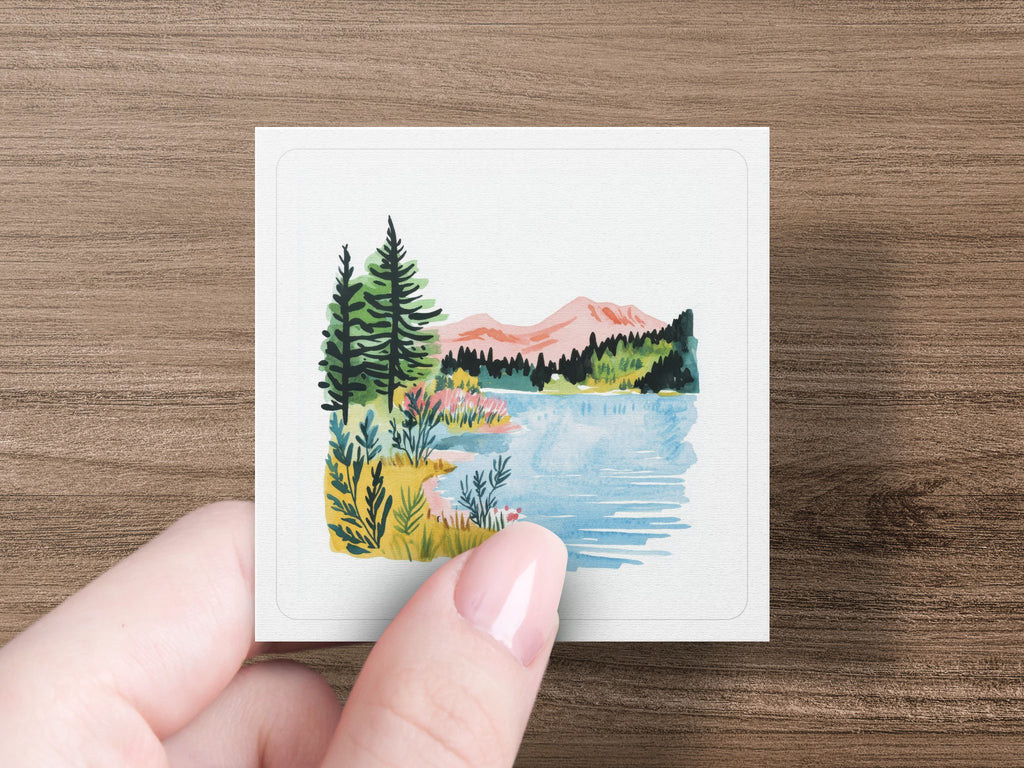 Watercolor painting of a lake, mountains, and evergreen trees.