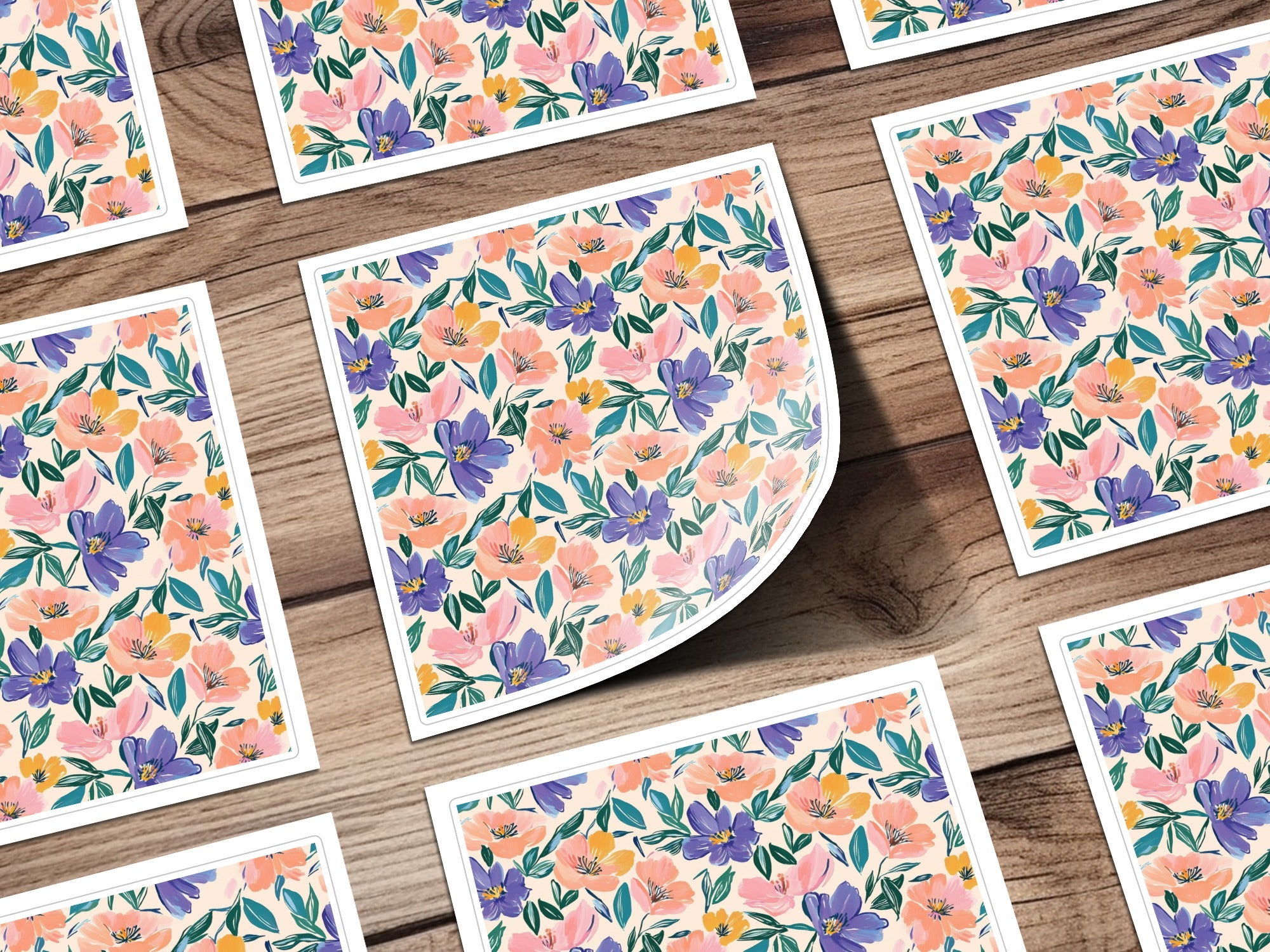 Floral pattern stickers with pink, purple, and coral flowers on wood grain background.