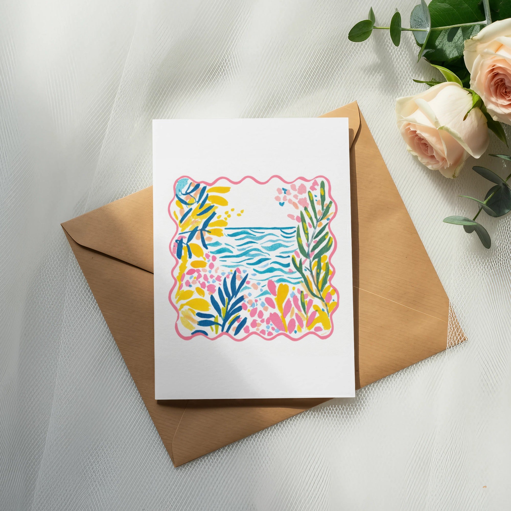 White card with colorful abstract floral and ocean scene on brown envelope.