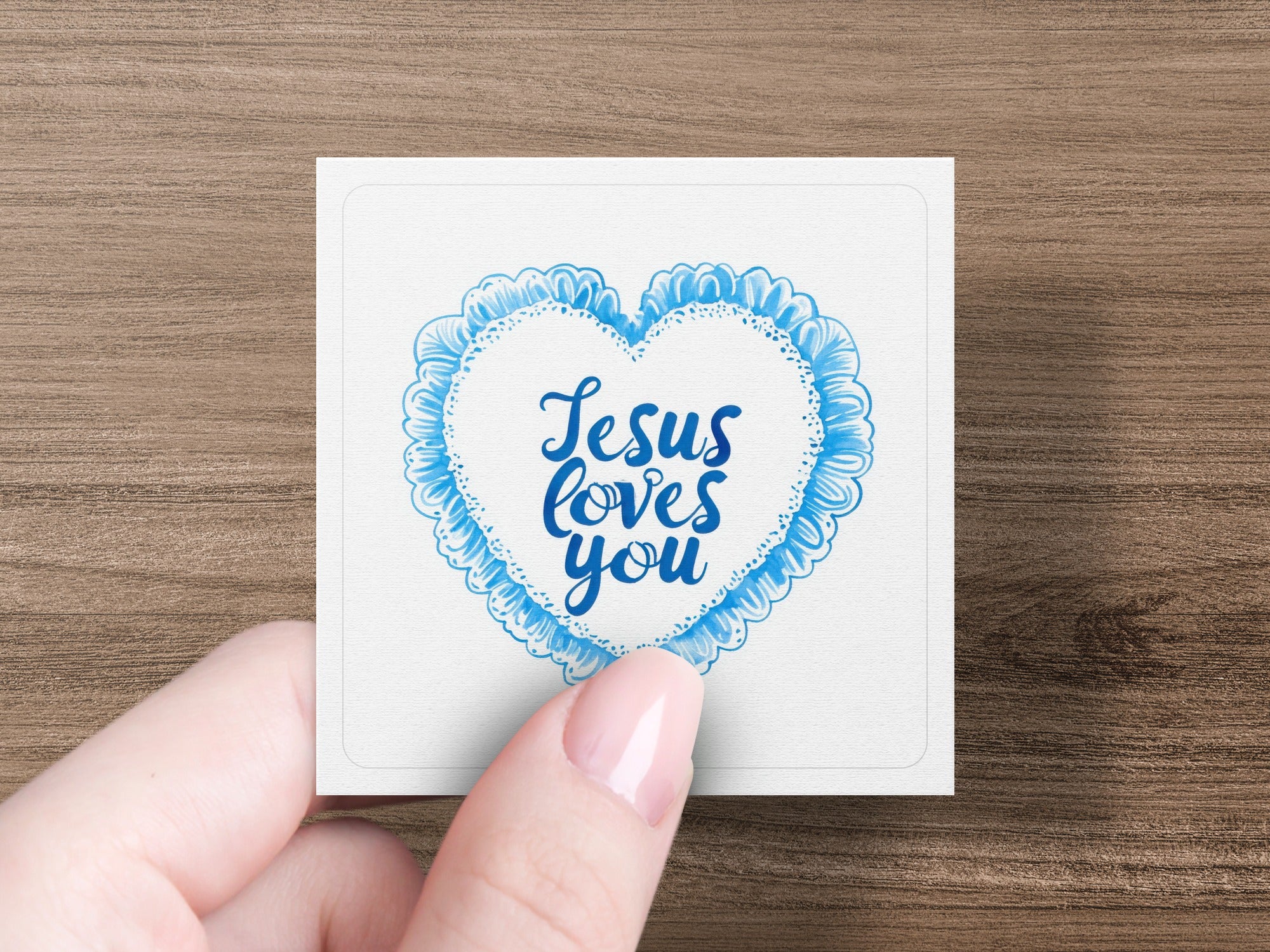 Square card with "Jesus loves you" in a blue heart outline.