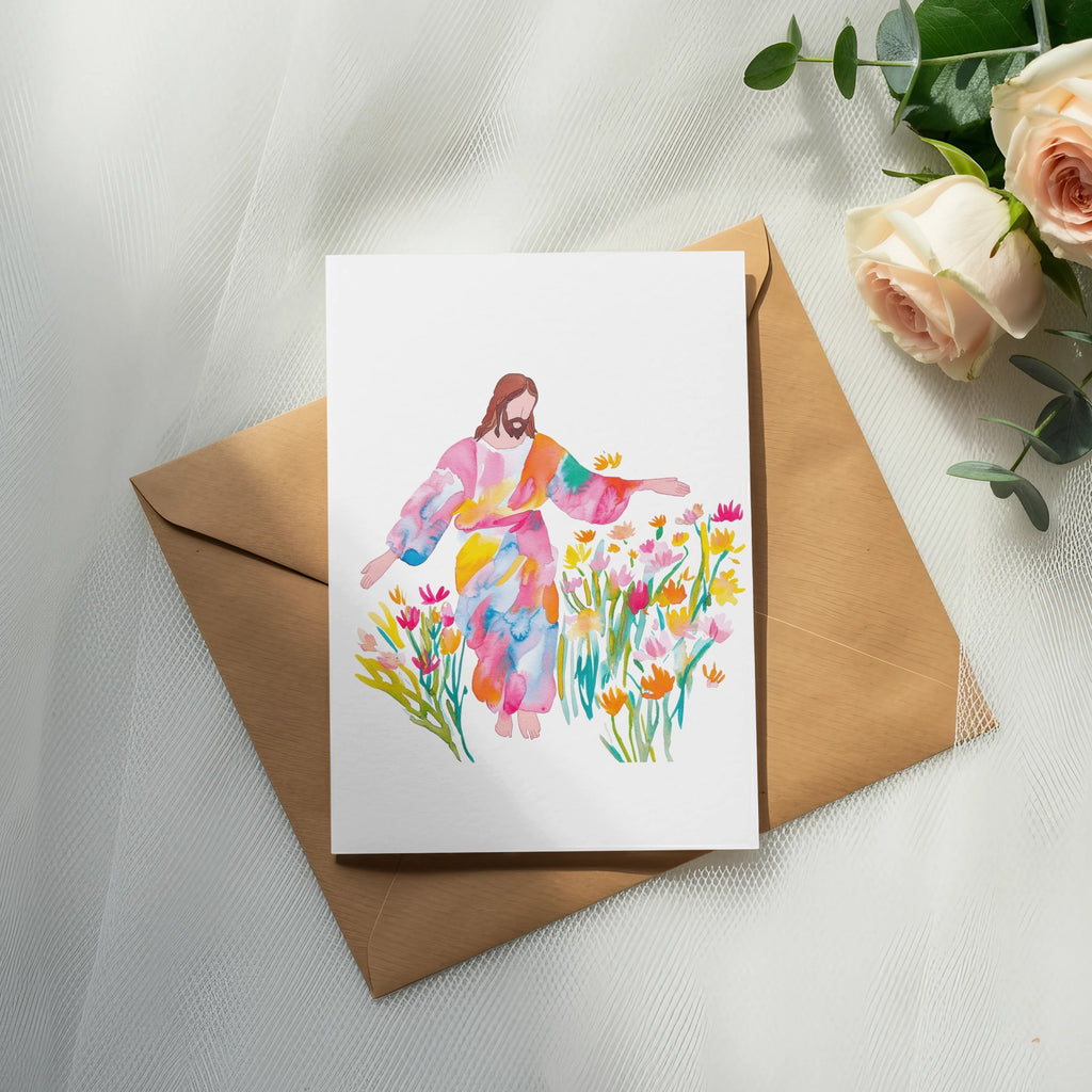 Watercolor painting of Jesus surrounded by colorful flowers on a brown envelope.