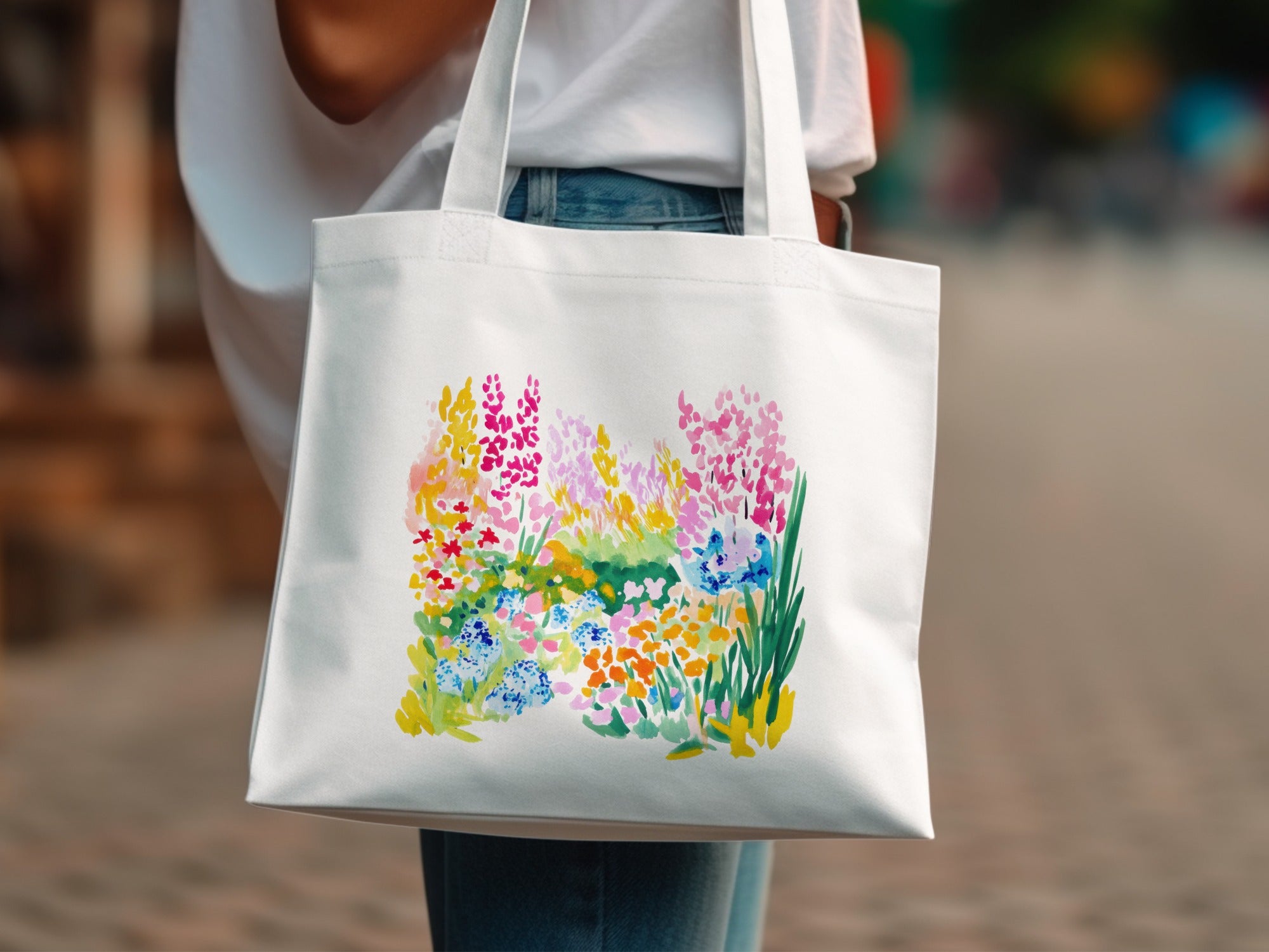 White canvas tote bag with a vibrant floral watercolor print.