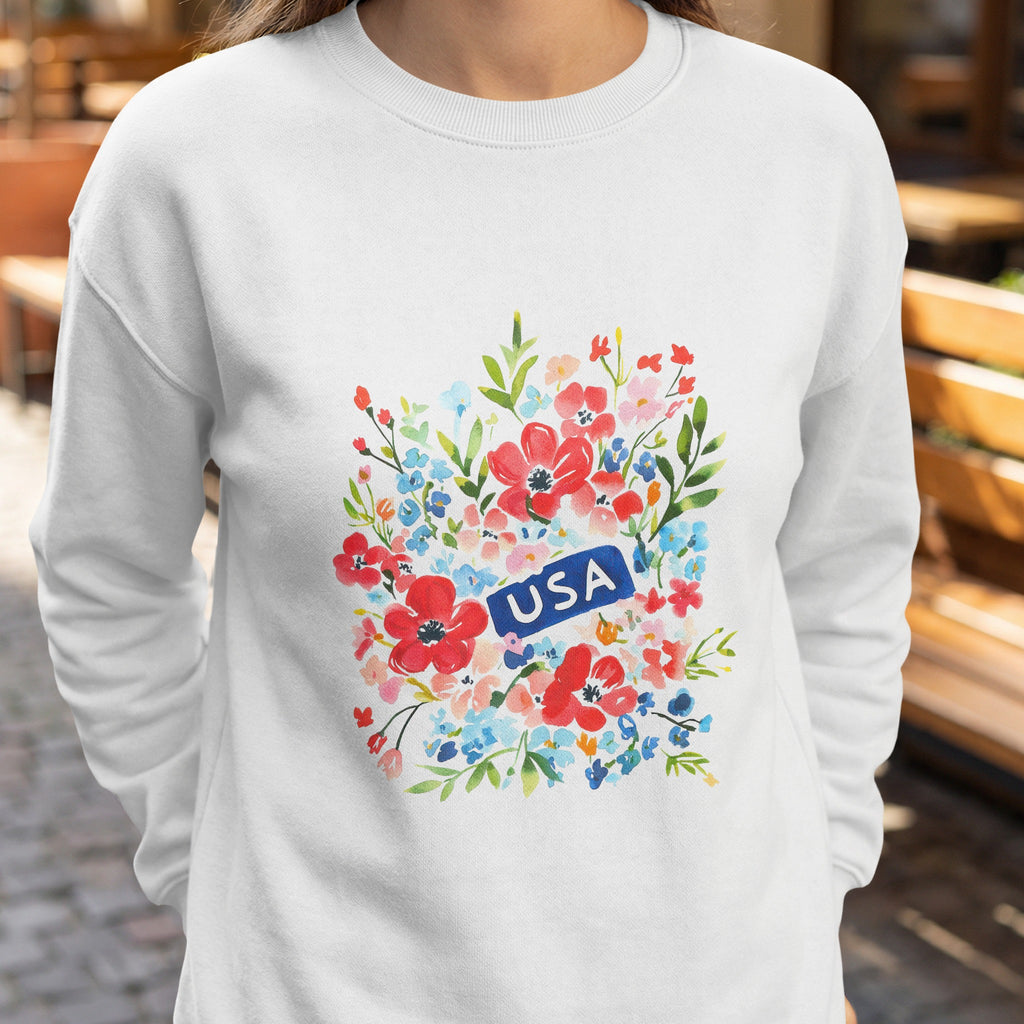 White sweatshirt with a floral design and a blue "USA" rectangle.