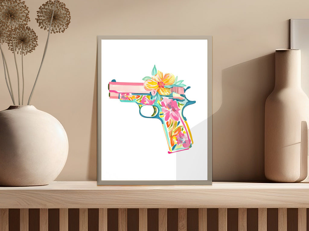 Colorful pistol with floral pattern on white background, framed.