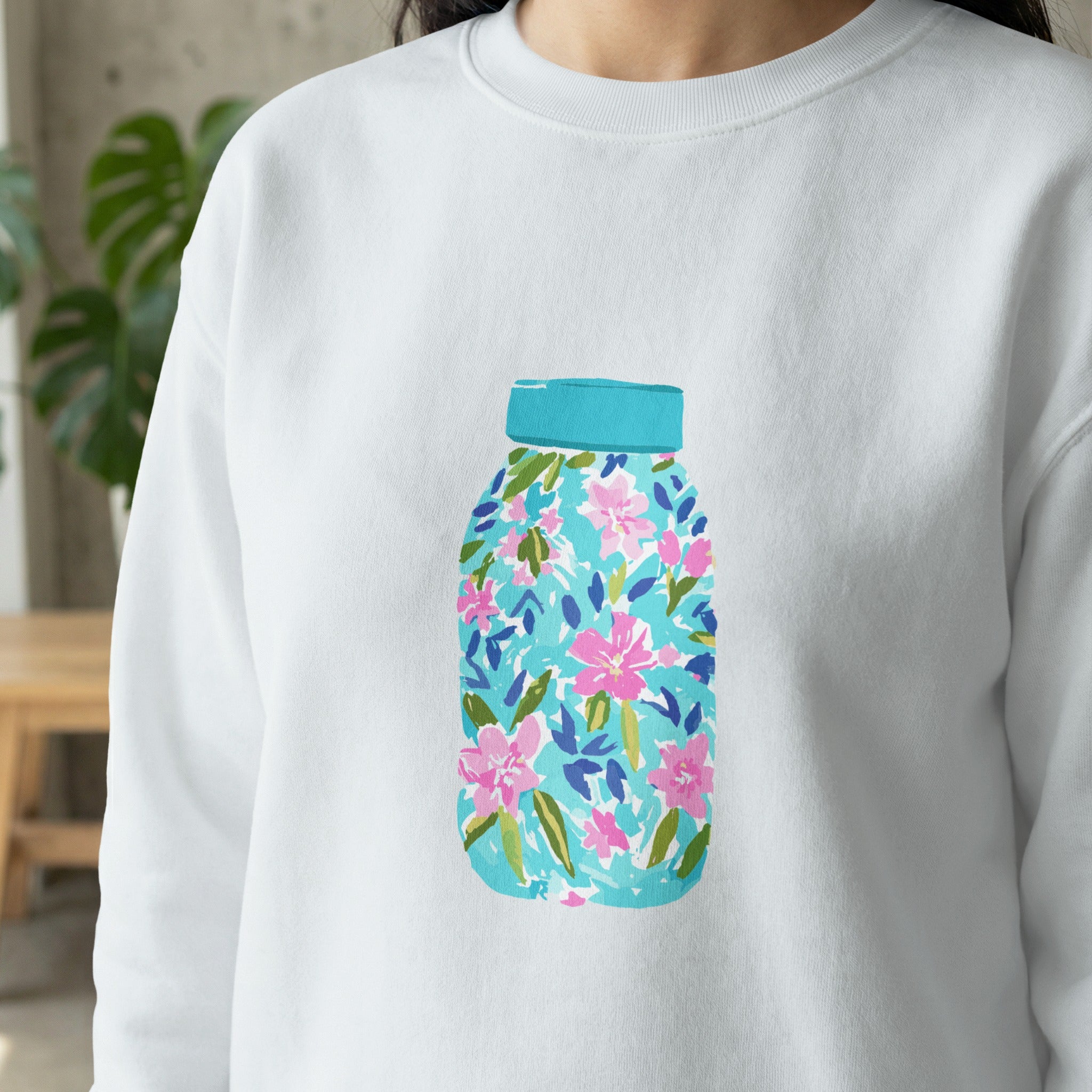 White sweatshirt with a colorful floral mason jar design.