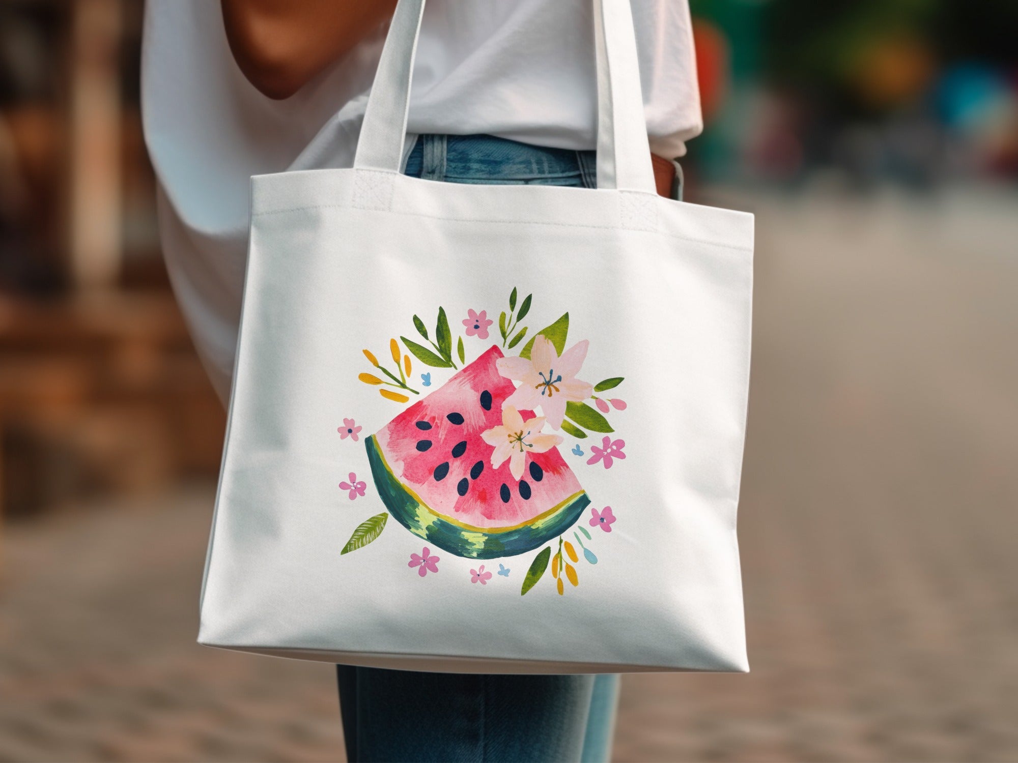 White tote bag with a watercolor watermelon slice and floral illustration.