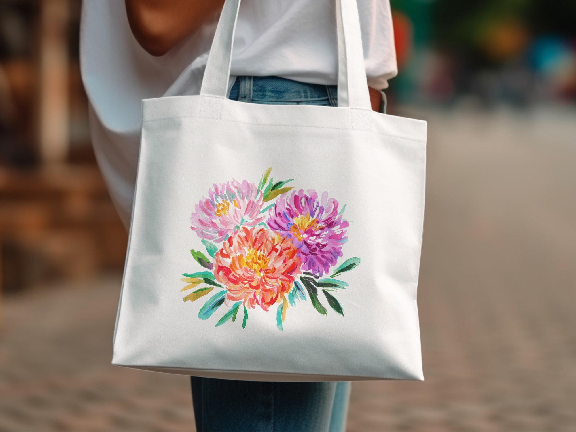 White tote bag with colorful floral illustration.