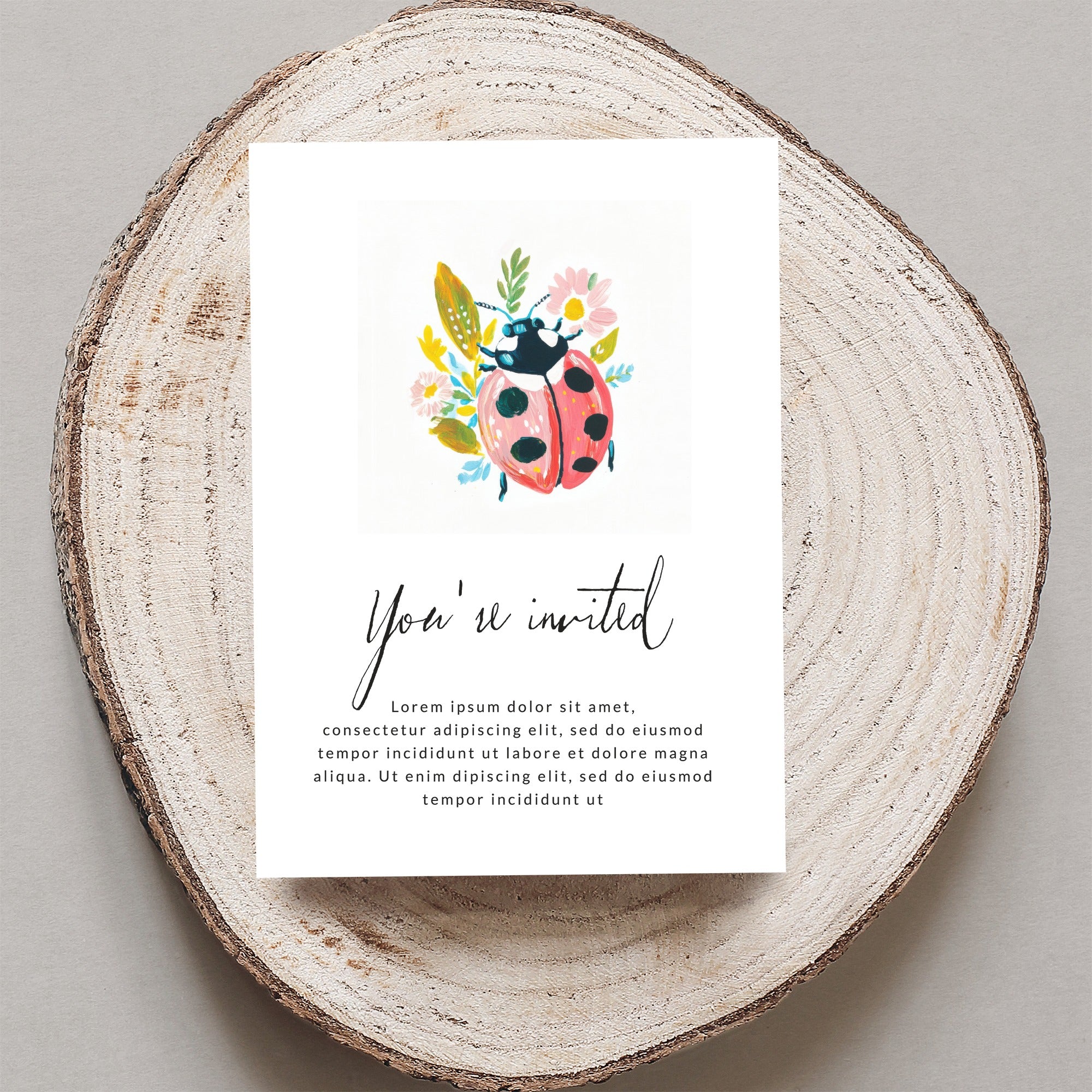 Ladybug invitation with floral accents and placeholder text.