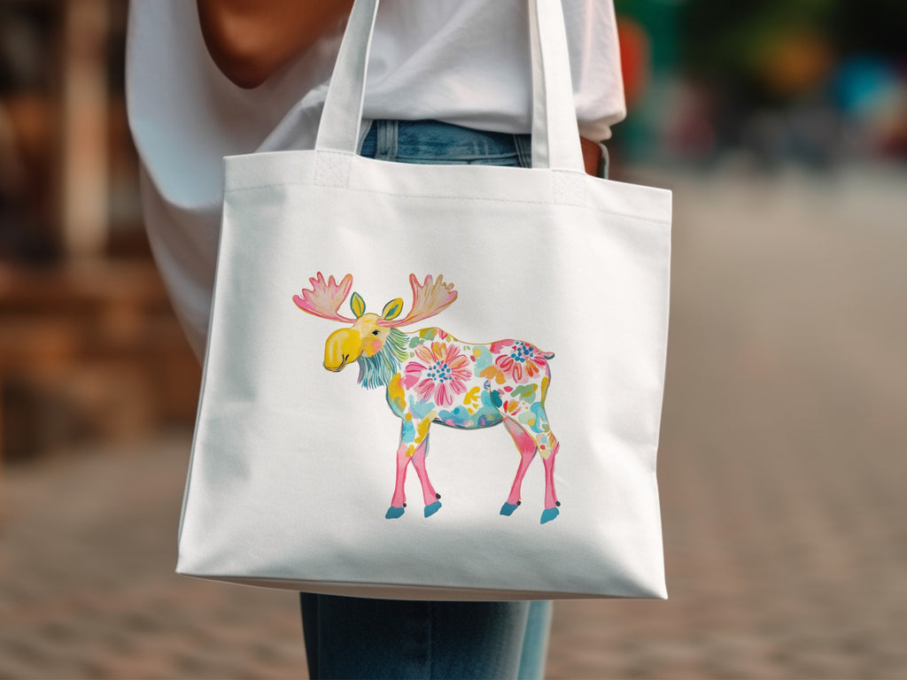 White tote bag with a colorful floral moose illustration.