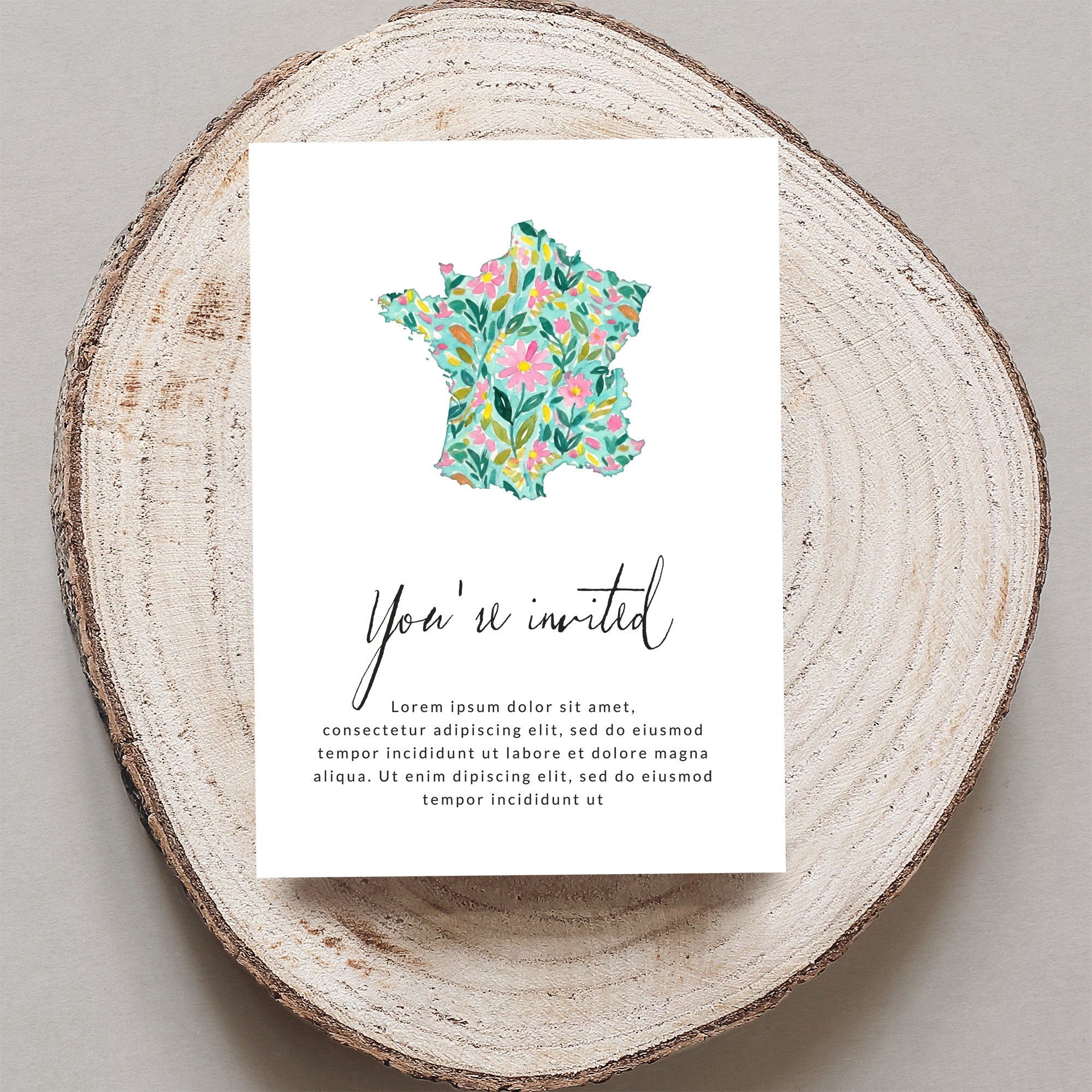 Invitation with floral France map and "You're invited" text.