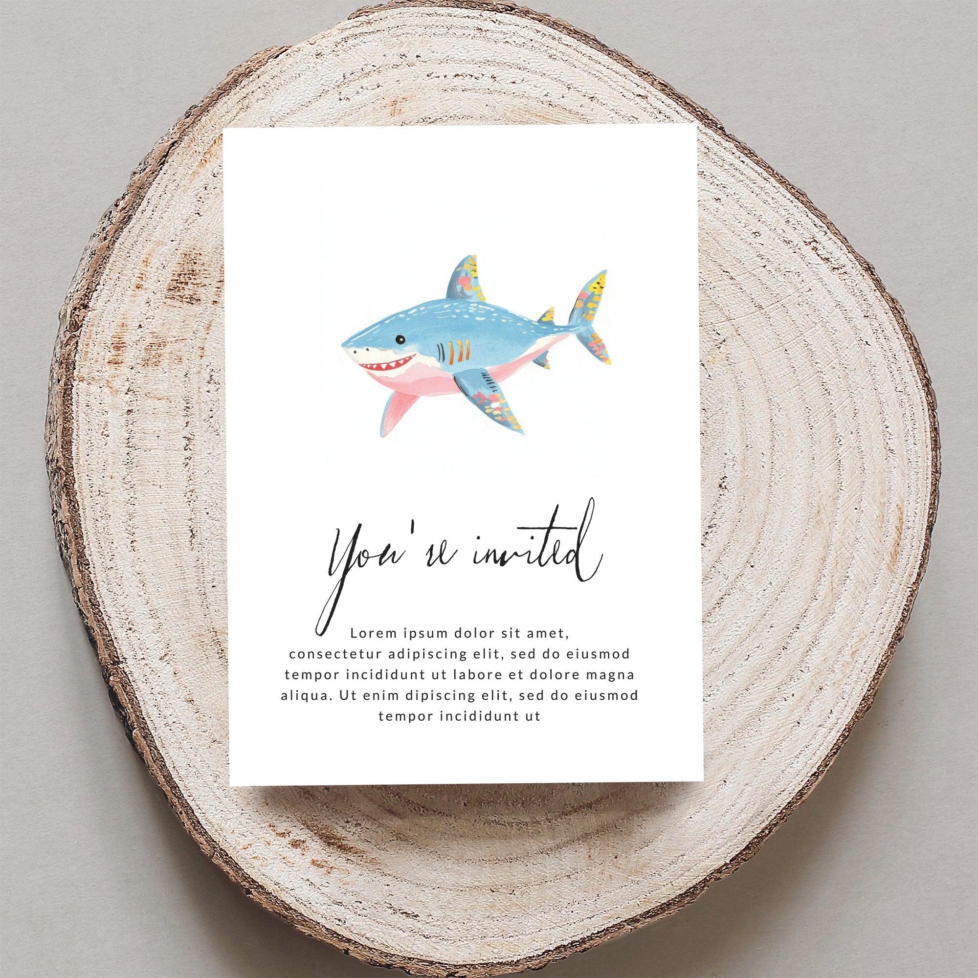 Shark invitation card with "You're invited" text.