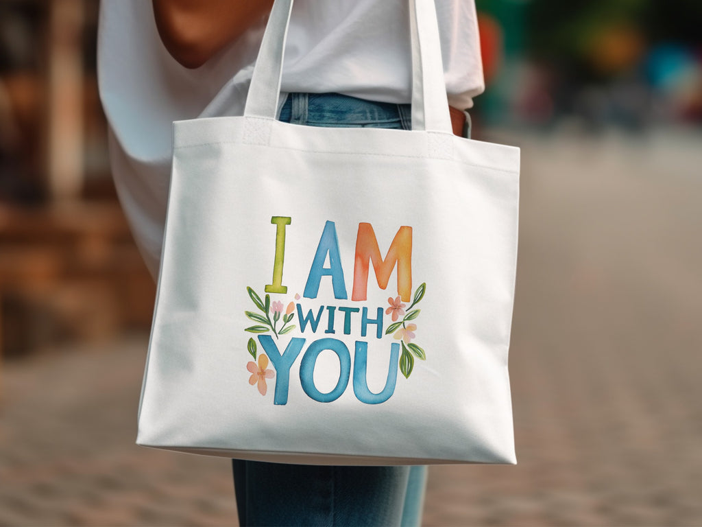 White tote bag with colorful "I AM WITH YOU" text and floral accents.