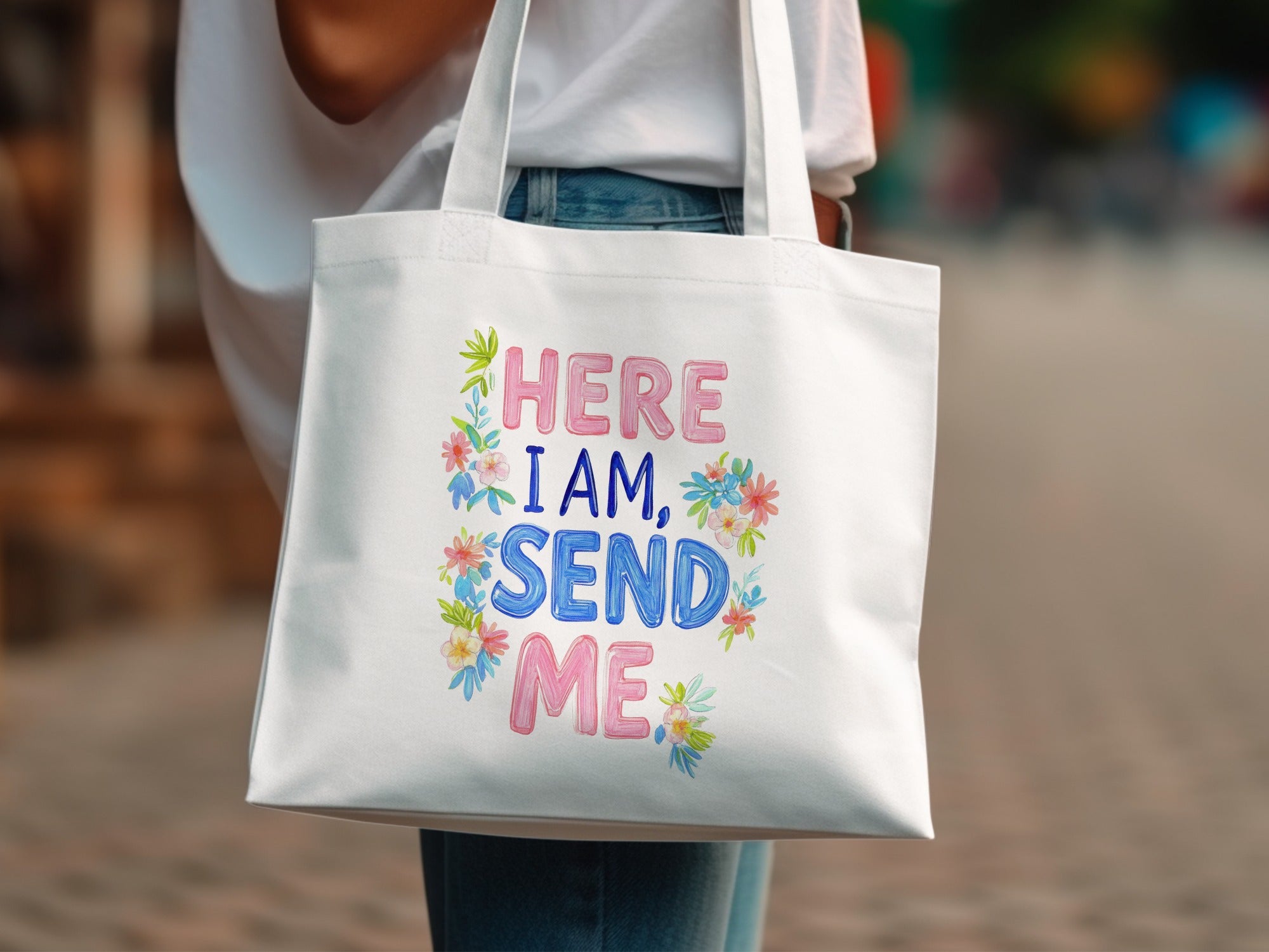 White tote bag with "HERE I AM, SEND ME" text and floral accents.