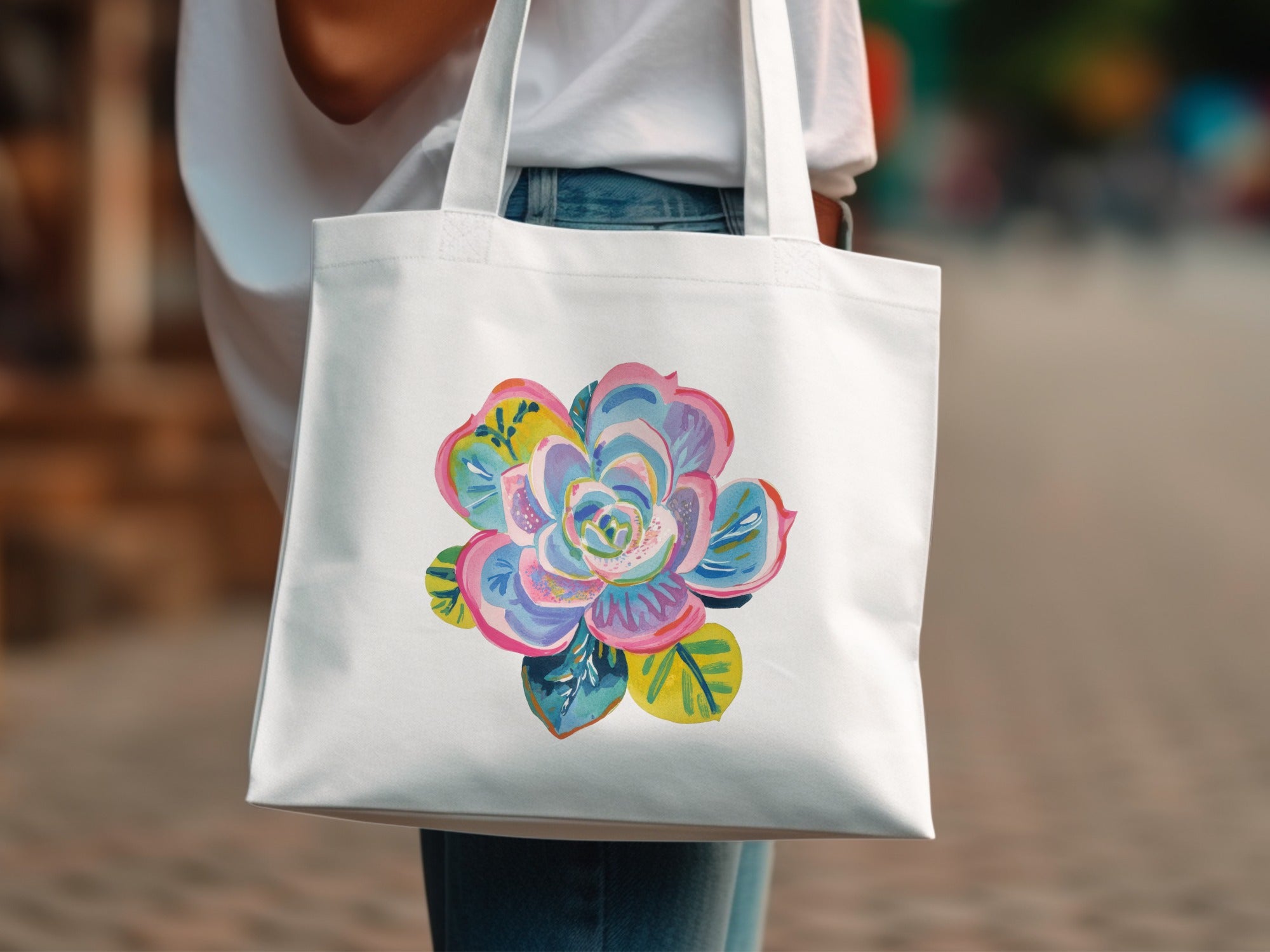 White tote bag with a colorful succulent floral illustration.