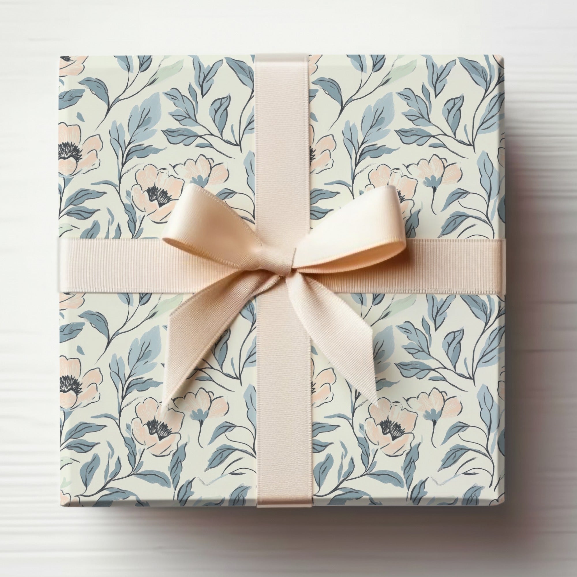 Gift-wrapped box with a floral pattern and a light pink ribbon bow.