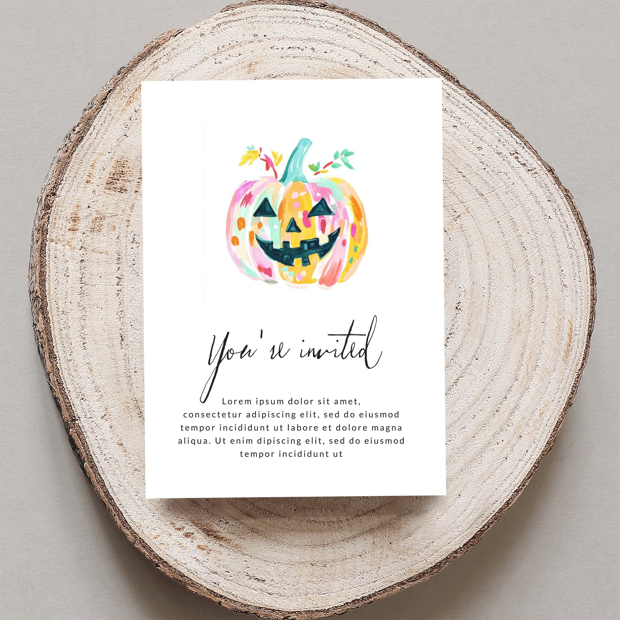 Watercolor Halloween invitation with jack-o'-lantern and "You're invited" text.