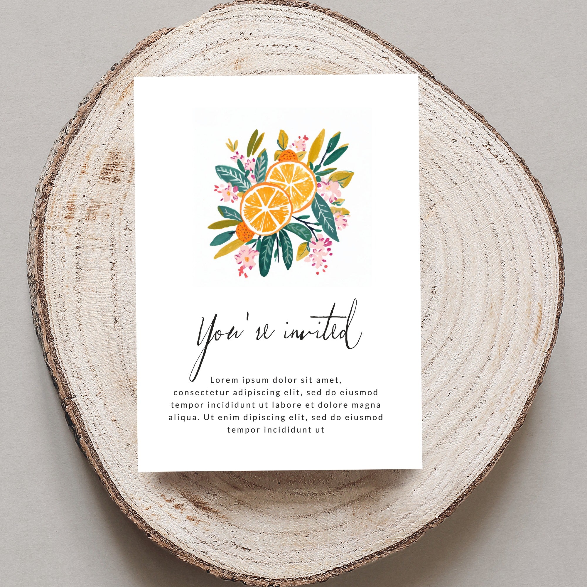 Invitation card with "You're invited" text and floral orange illustration on wood.