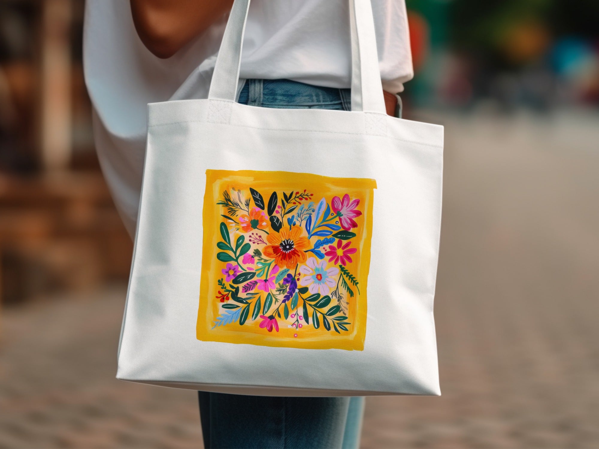 White canvas tote bag with a vibrant, abstract floral pattern.
