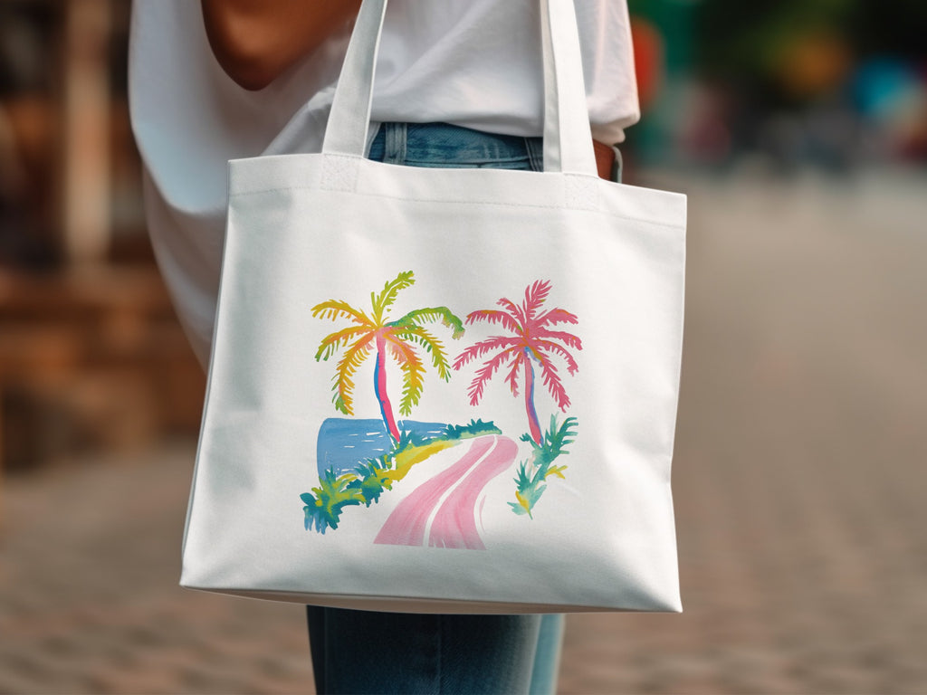 White tote bag with colorful palm trees, road, and ocean illustration.