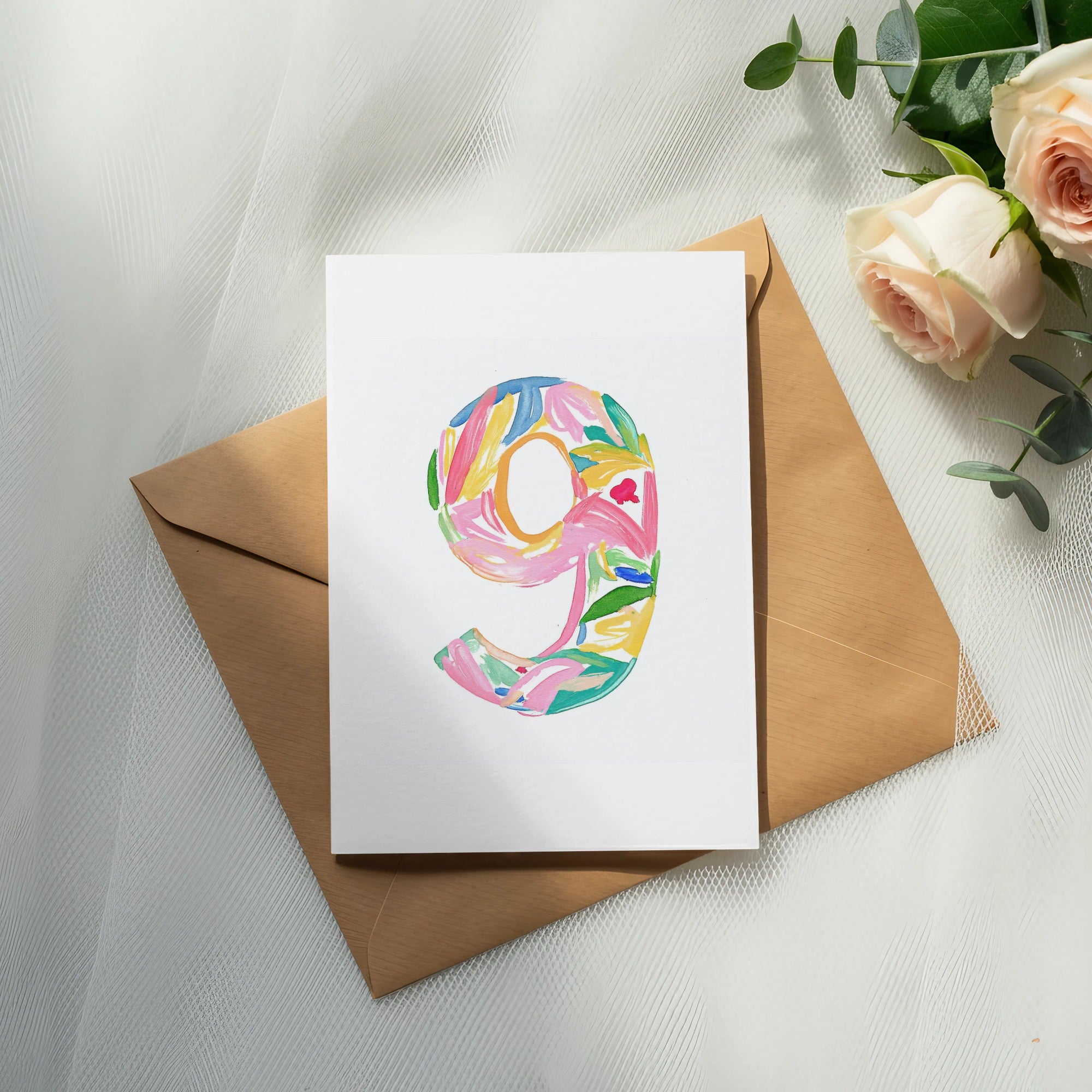 White card with "9" in colorful floral watercolor design on envelope.