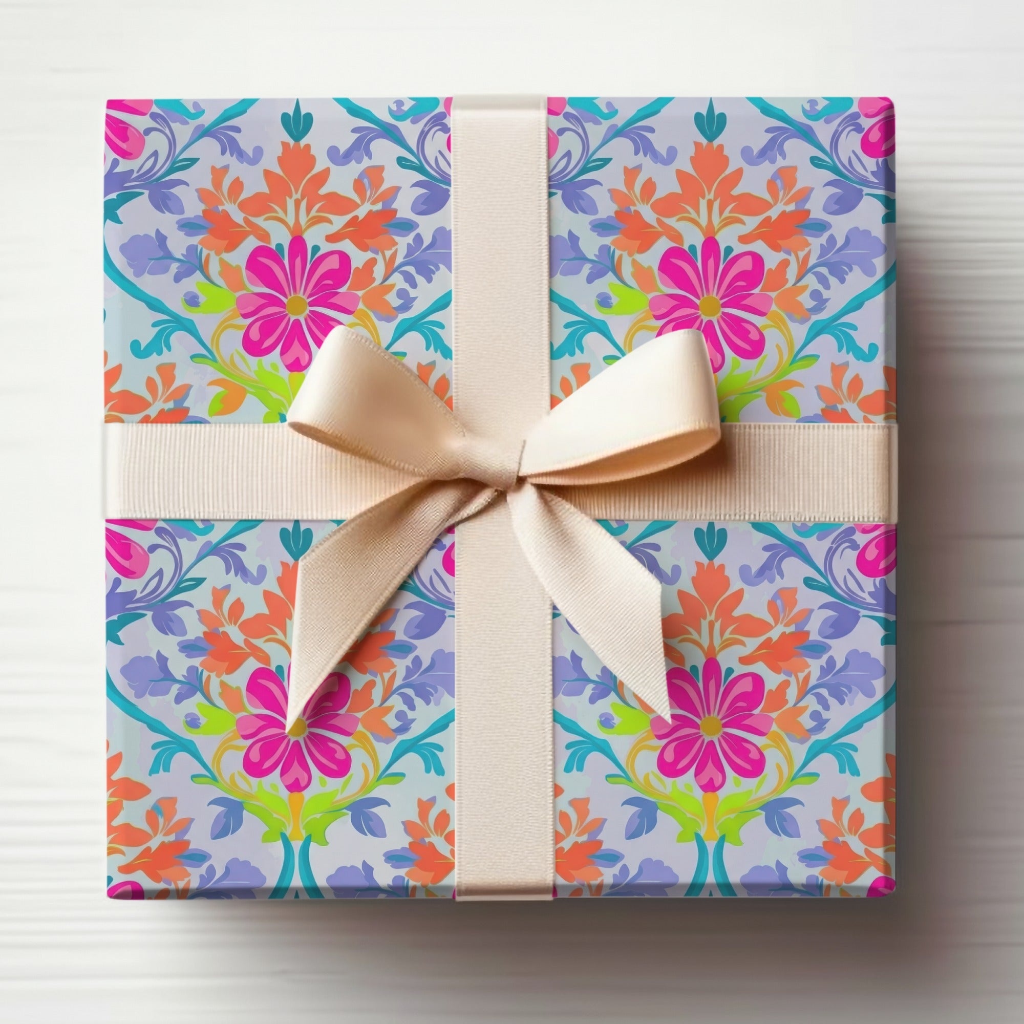 Gift-wrapped box with floral pattern and light beige ribbon bow.