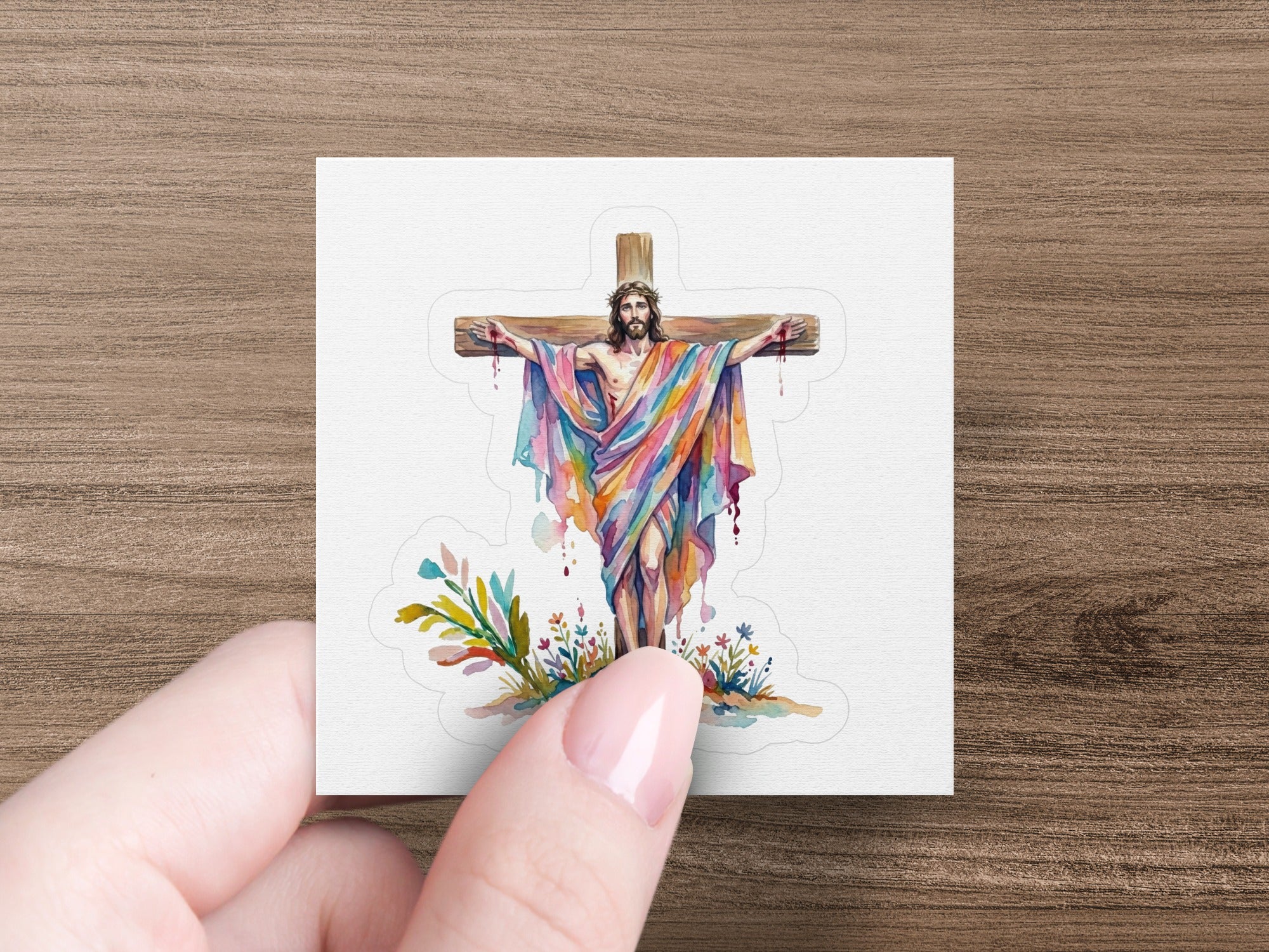 Jesus on the cross with a rainbow-colored robe and floral accents.