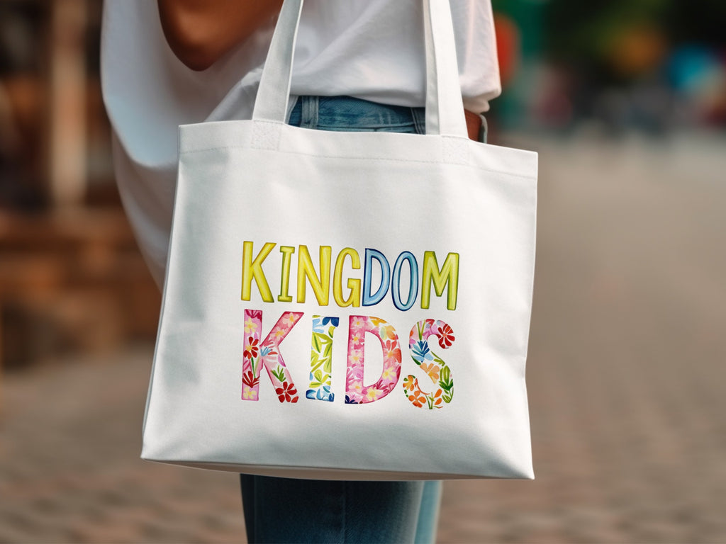 White tote bag with colorful "Kingdom Kids" text and floral accents.