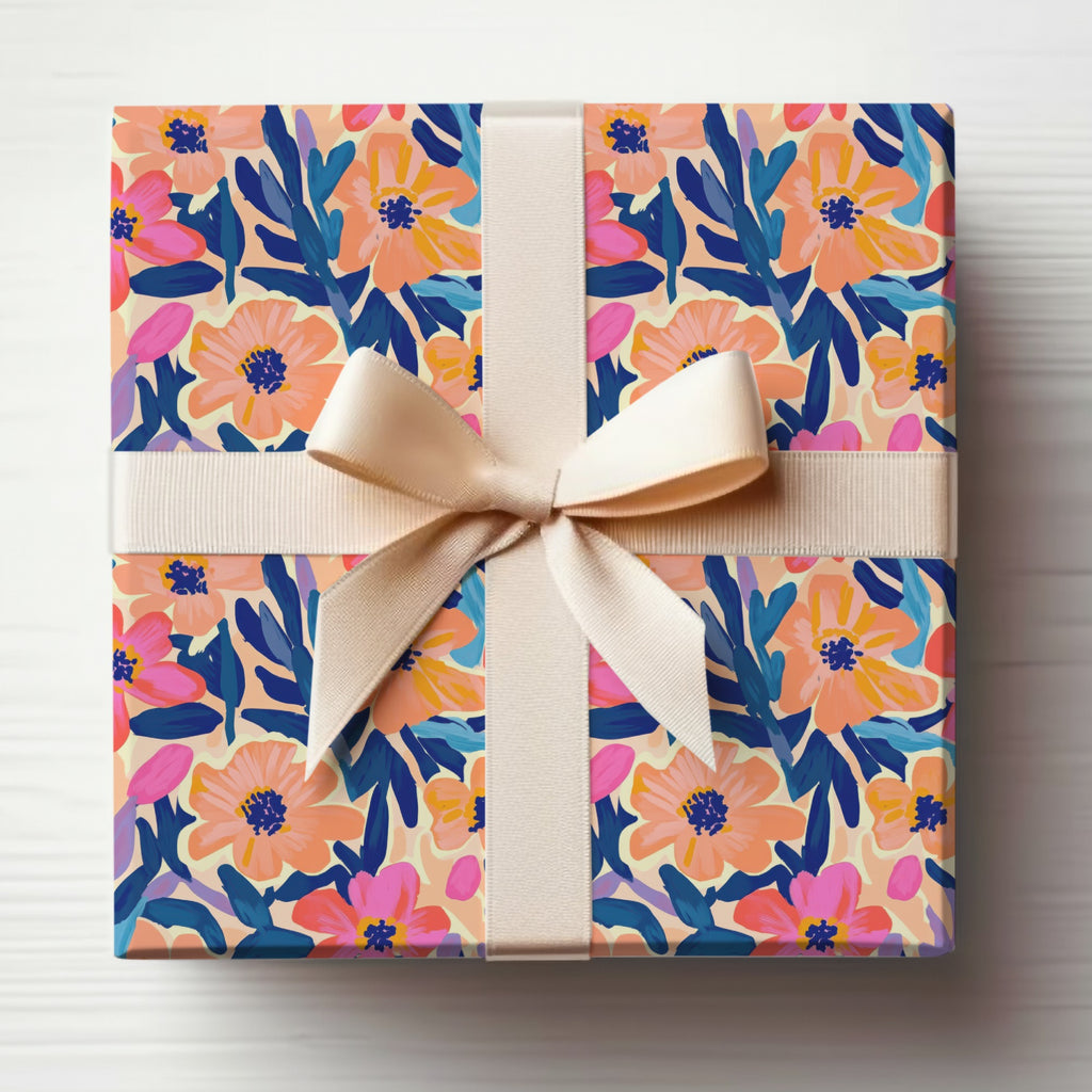 Gift box with cream ribbon, featuring a floral pattern of pink, coral, and blue shapes.