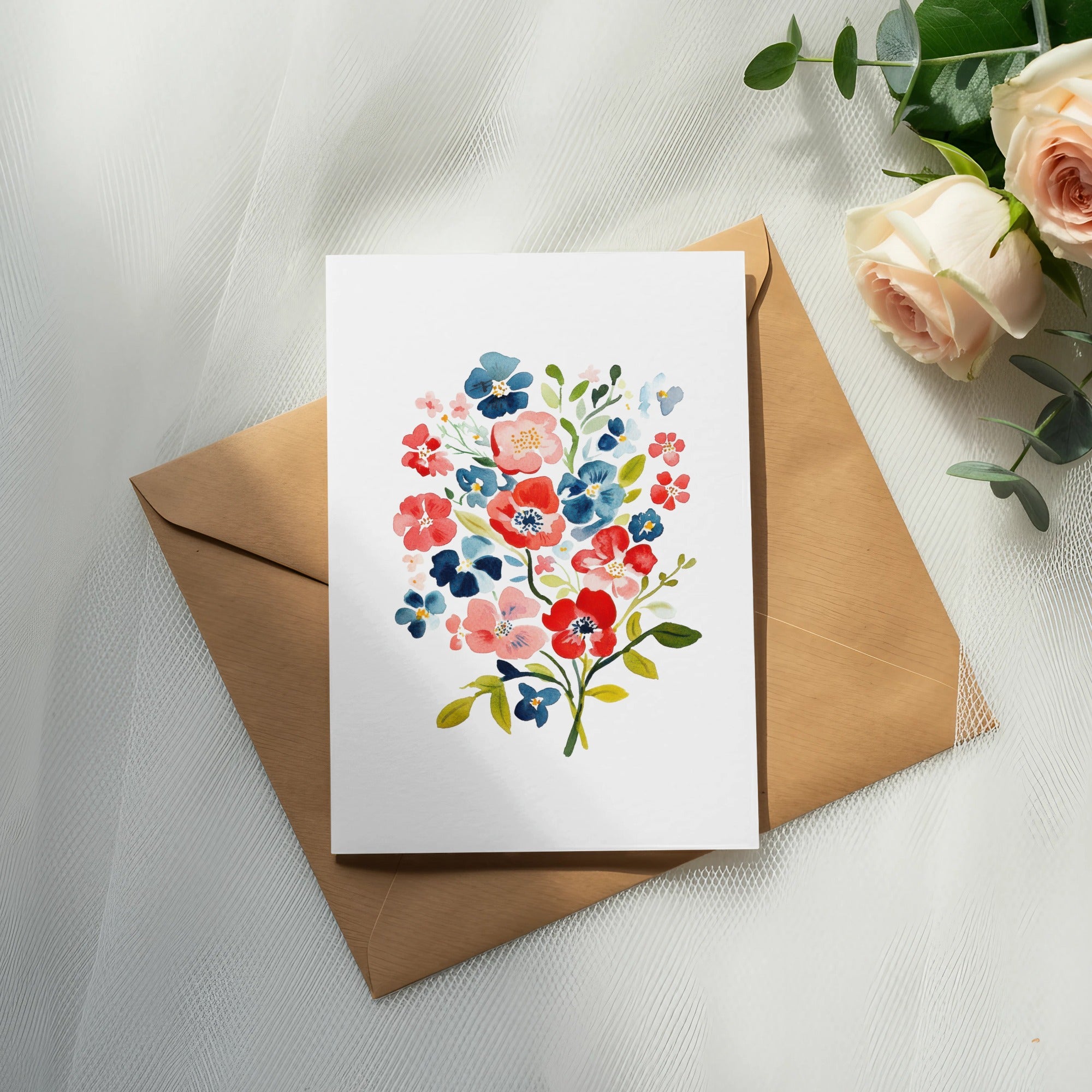 Watercolor floral illustration on a card atop a brown envelope.