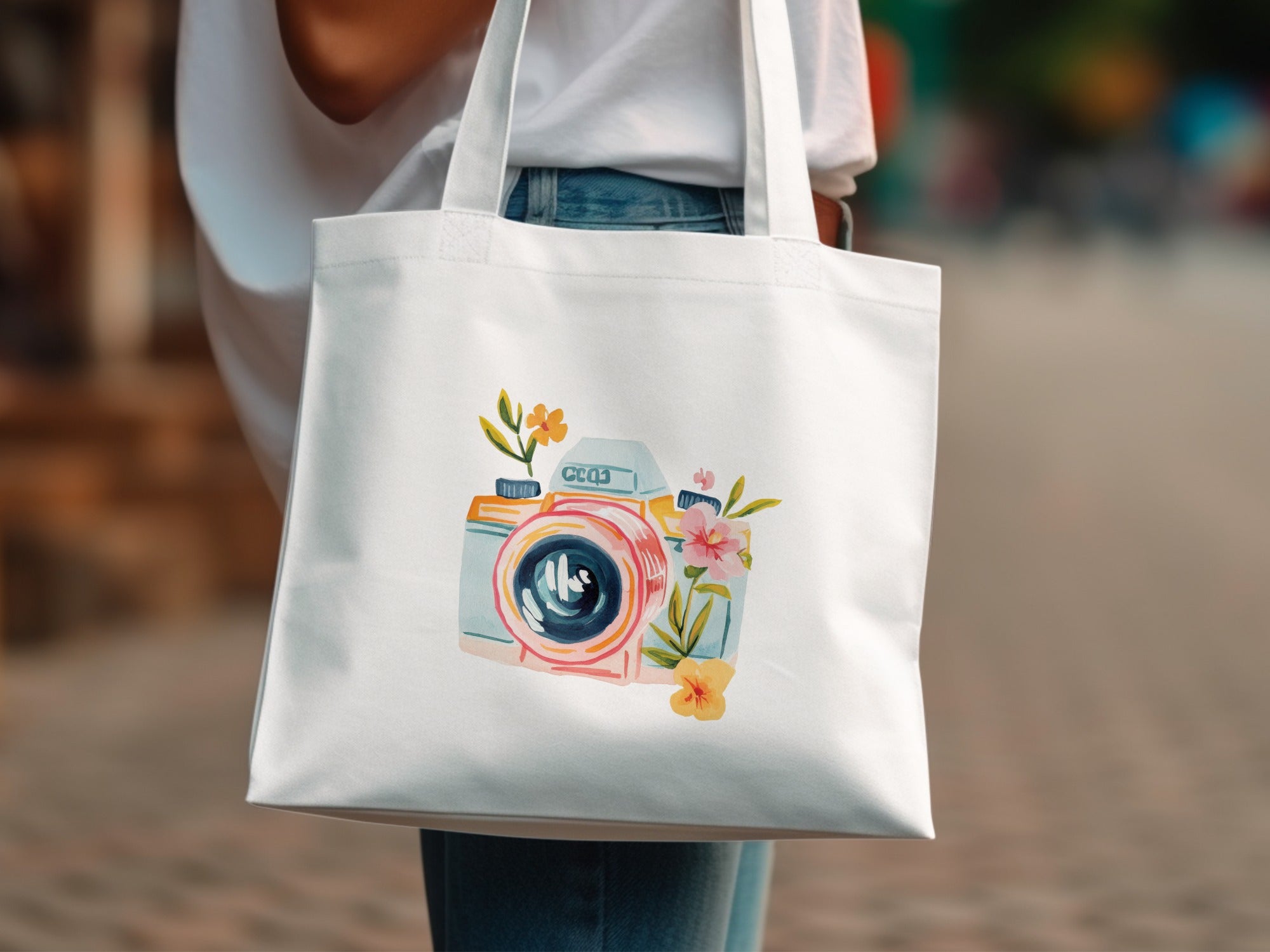 White canvas tote bag with a watercolor camera and floral design.