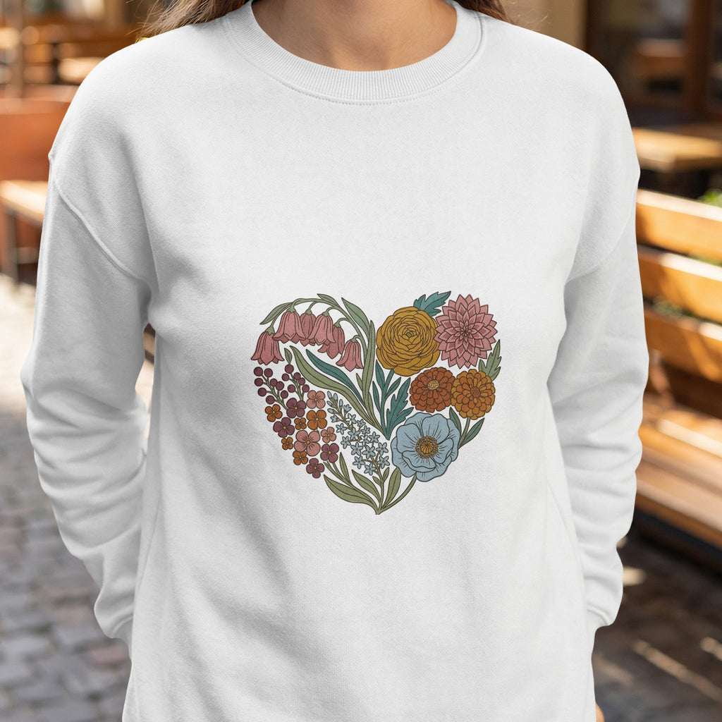 White sweatshirt with a heart-shaped floral design.