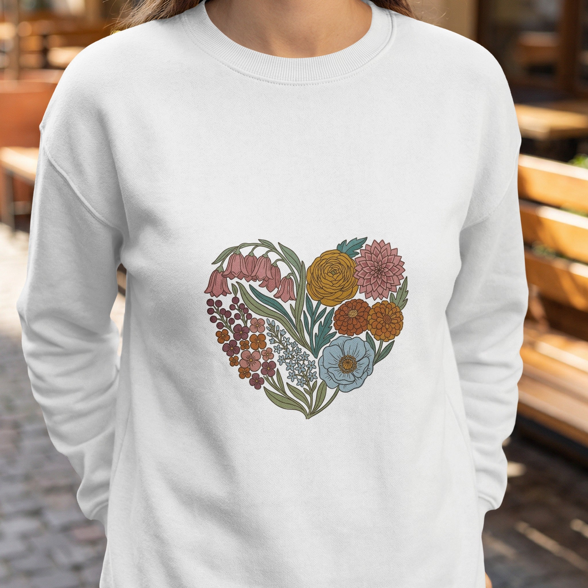 White sweatshirt with a heart-shaped floral design.