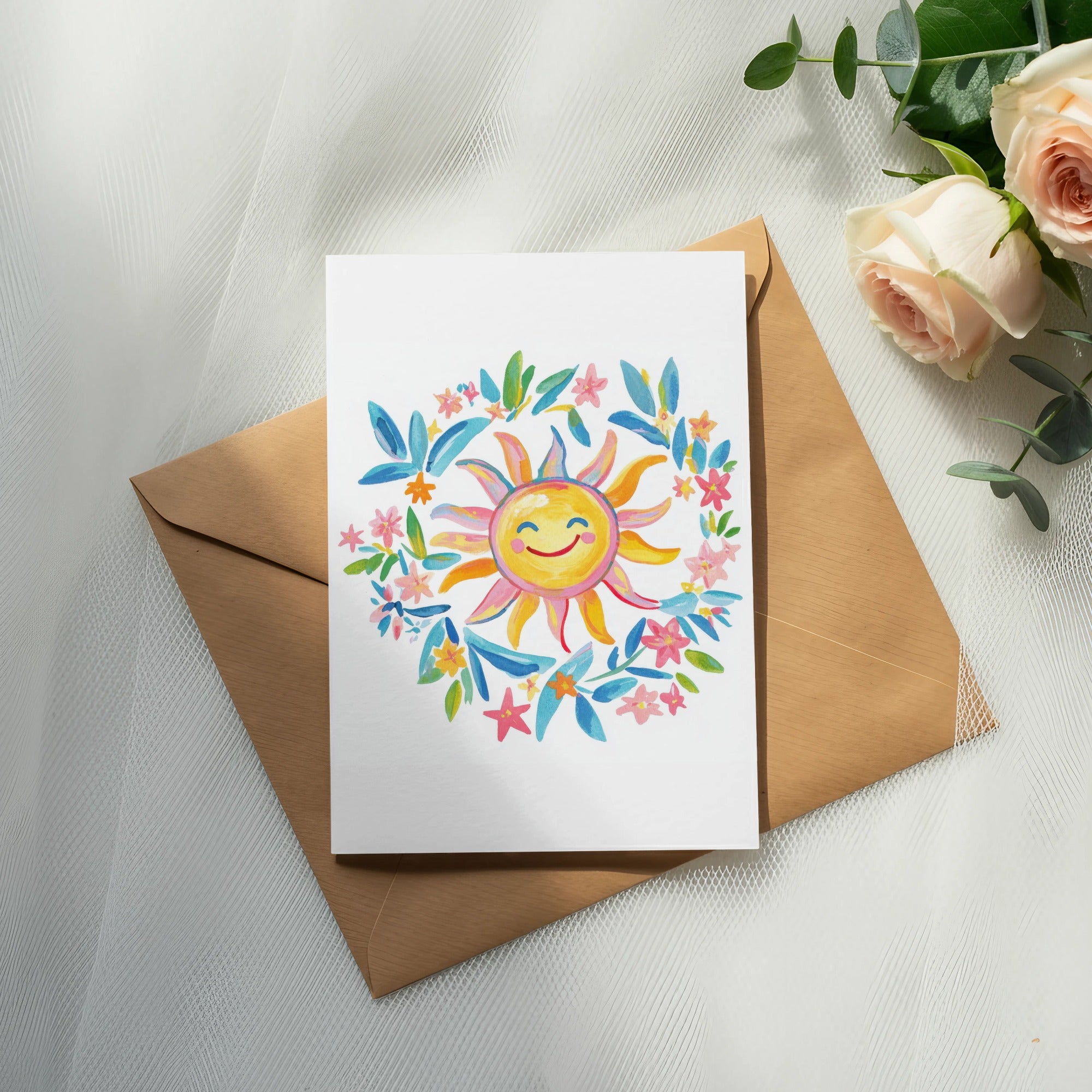 Watercolor sun with colorful floral wreath on a blank card and envelope.
