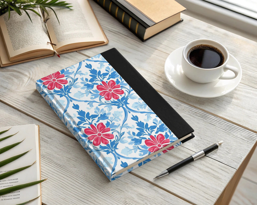 Floral pattern journal with pen and coffee on a wooden desk.
