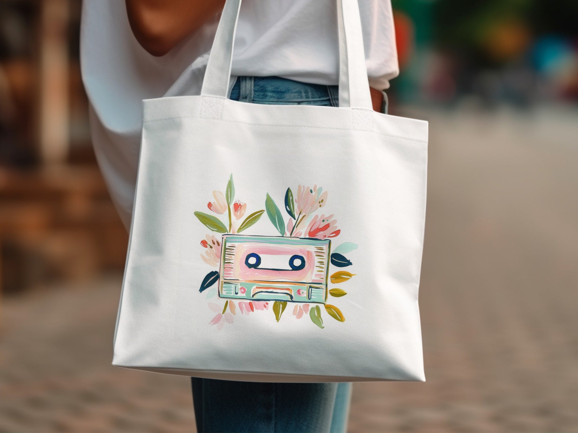 White tote bag with watercolor cassette tape and flowers illustration.