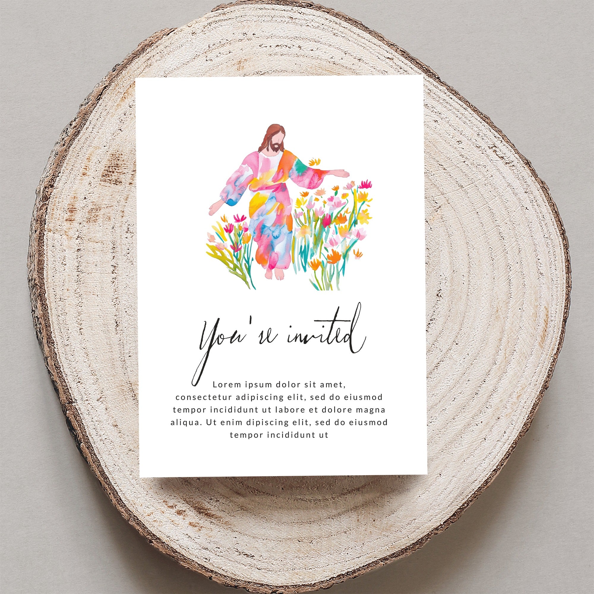 Invitation with watercolor Jesus among flowers and "You're invited" text.