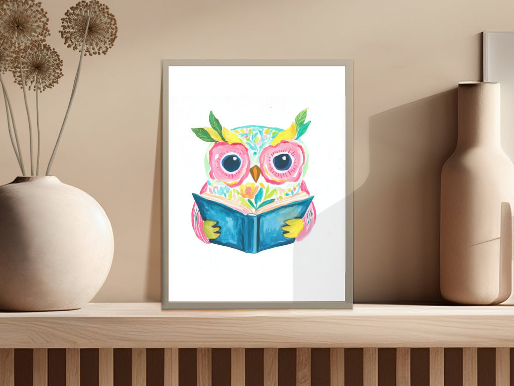 Watercolor owl with bright eyes reading an open book, framed.